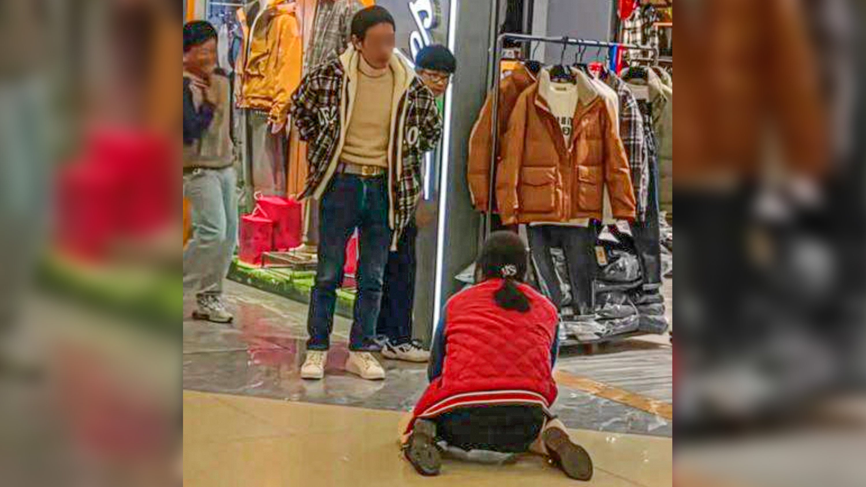 A man from Hubei, China, sparked outrage after he made his wife kneel and beg him to buy her a down jacket priced at just 299 yuan. Photo: Douyin