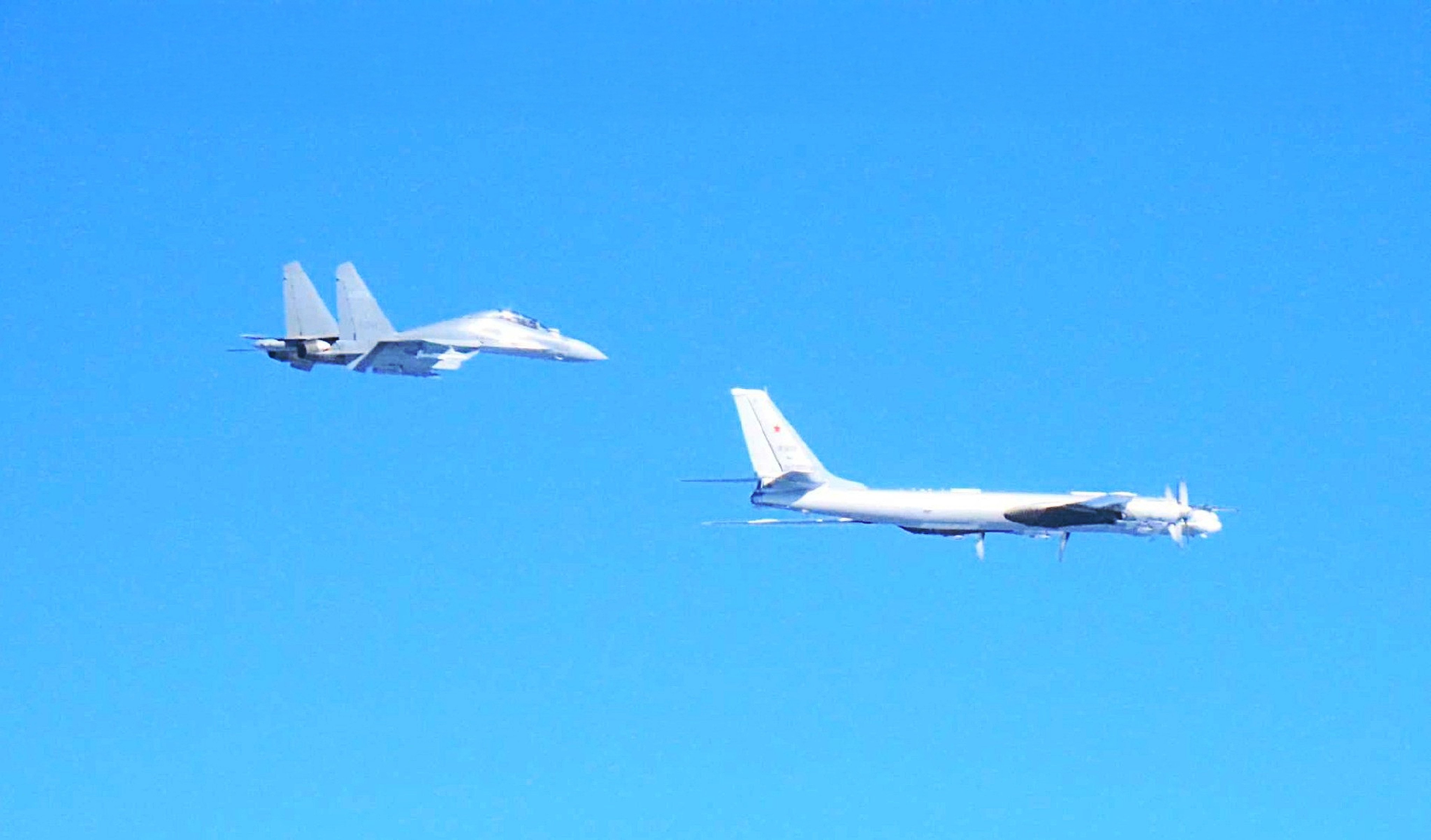 A Chinese J-16 fighter and a Russian Tu-95 bomber. Photo: Handout