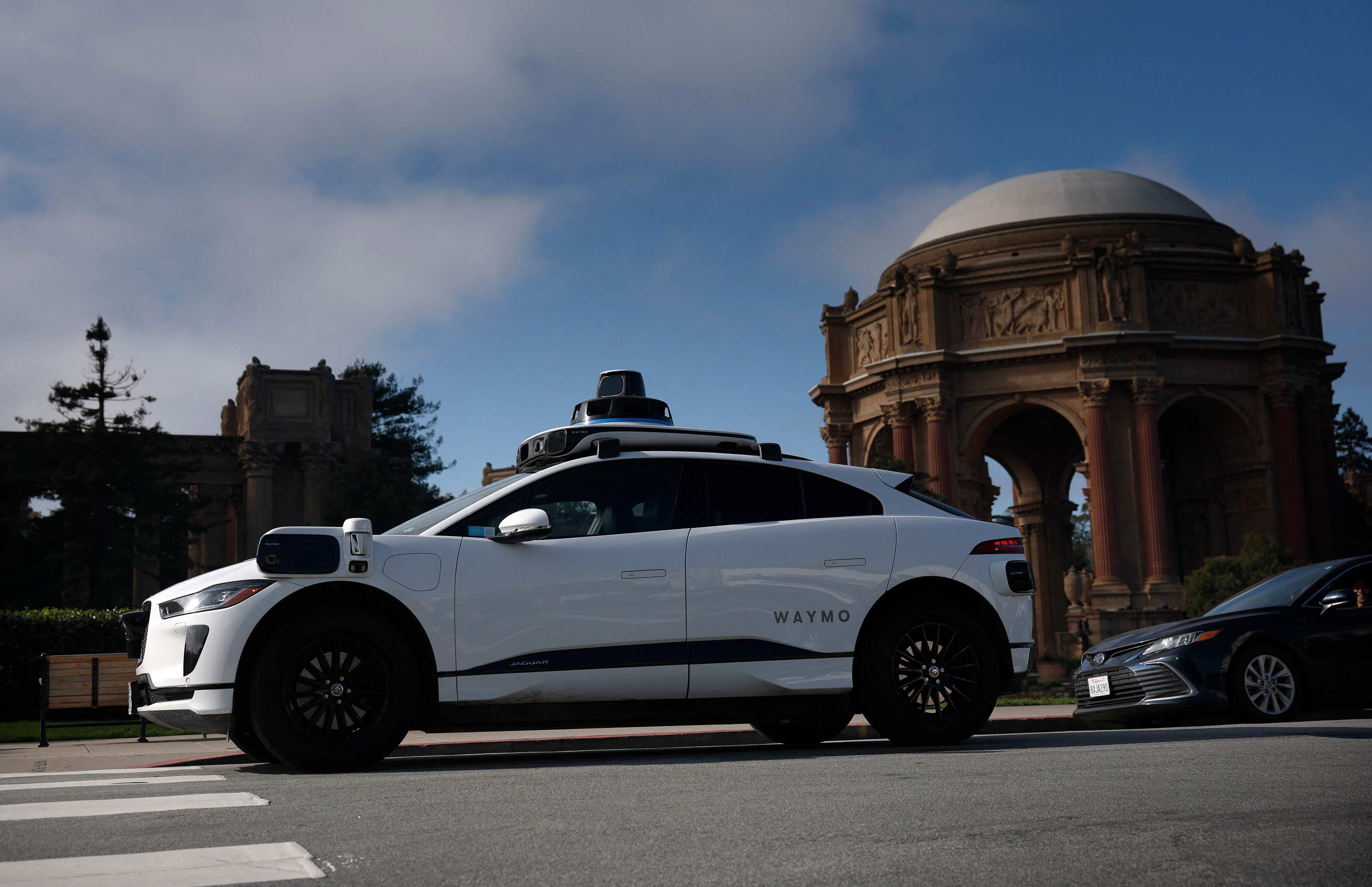A Waymo robotaxi drives by the Palace of Fine Arts in San Francisco on Monday. Photo: AFP