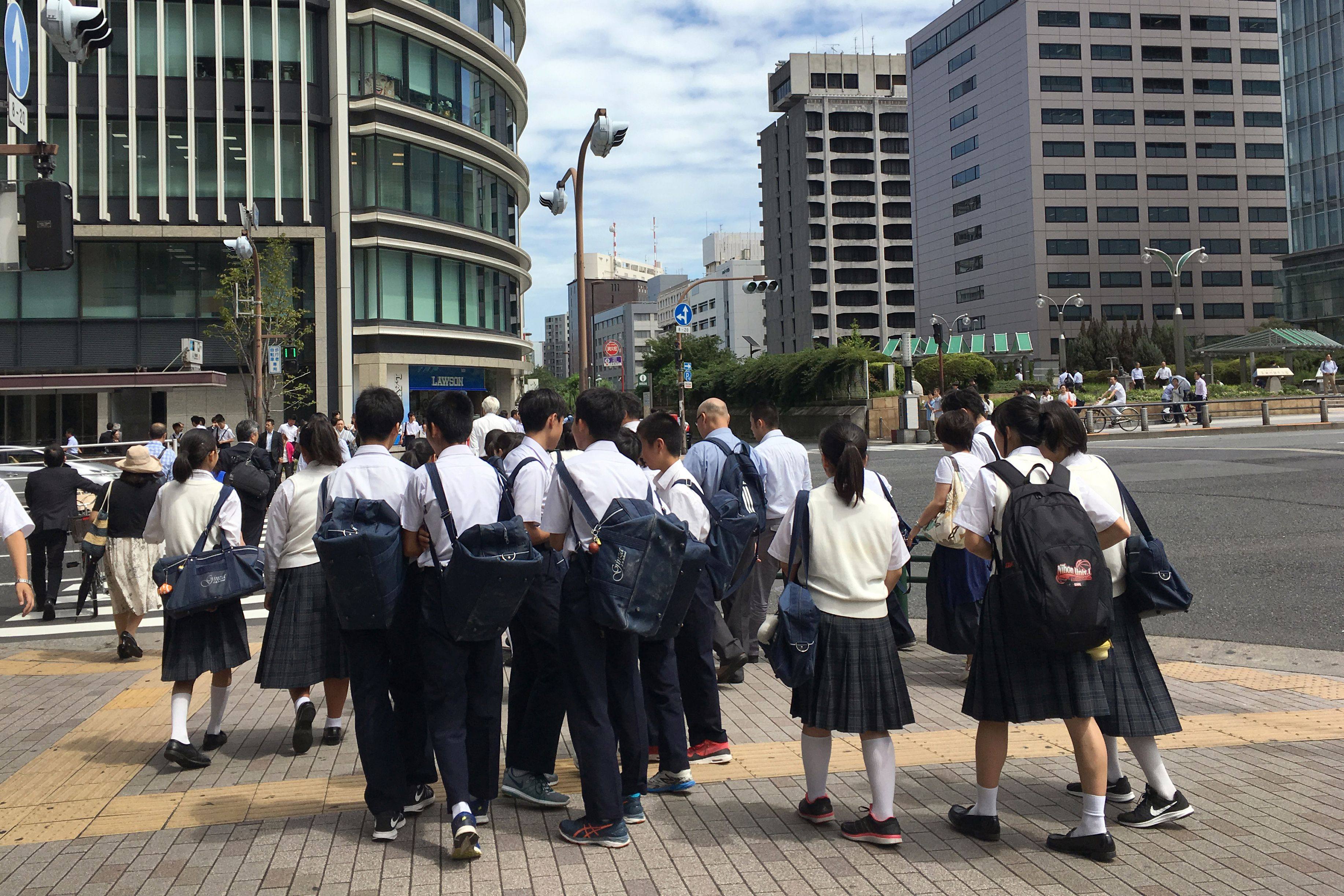 Japanese schoolchildren cross a street in Tokyo. English proficiency is dropping in Japan, a fact that some critics are attributing to outdated teaching methods. Photo: AFP