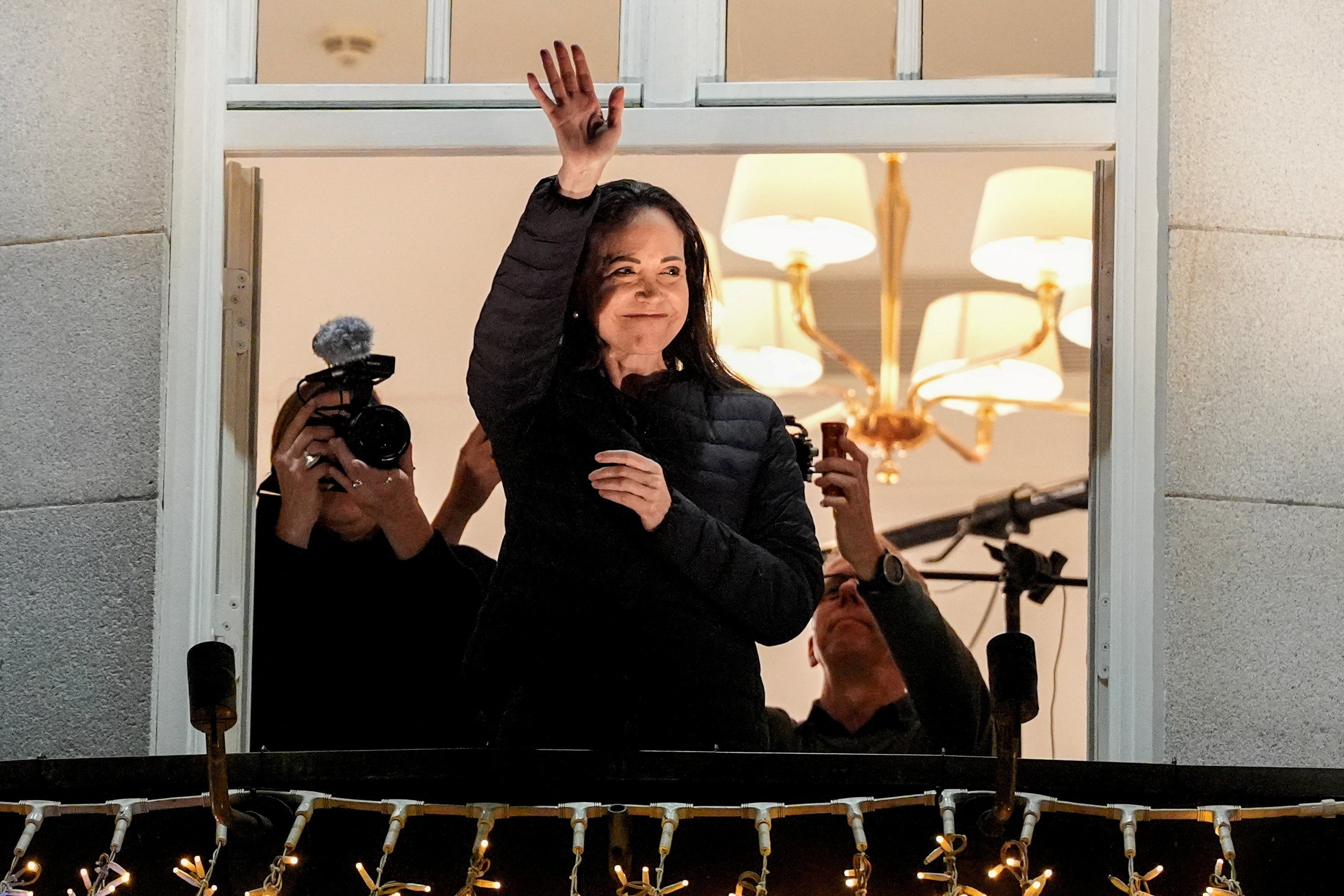 Maria Corina Machado waves from the balcony at the Grand Hotel in Oslo. Photo: Lise Aserud/NTB via Reuters