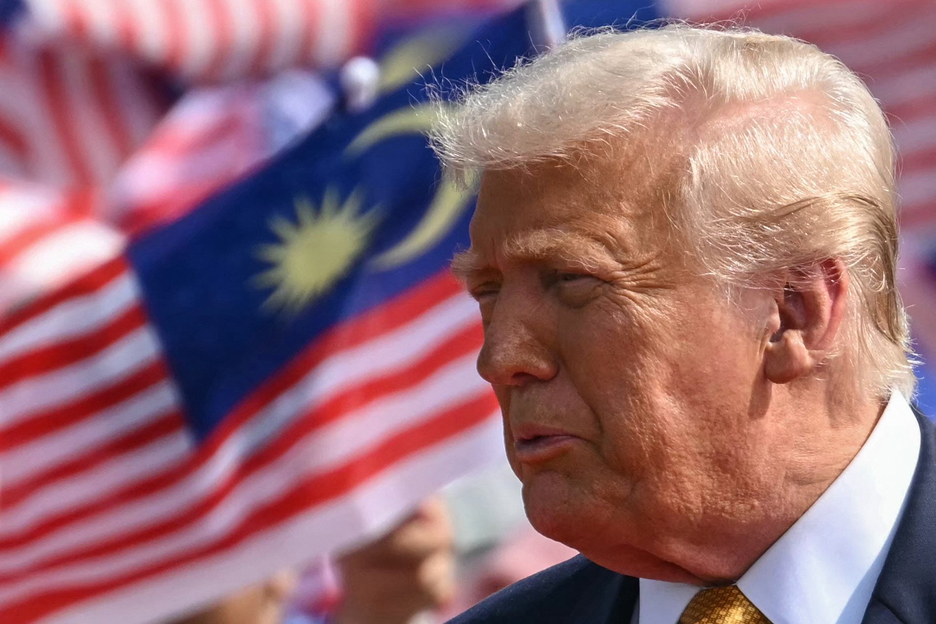 US President Donald Trump is pictured next to Malaysian flags before departing Kuala Lumpur International Airport on Air Force One in October. Photo: AFP