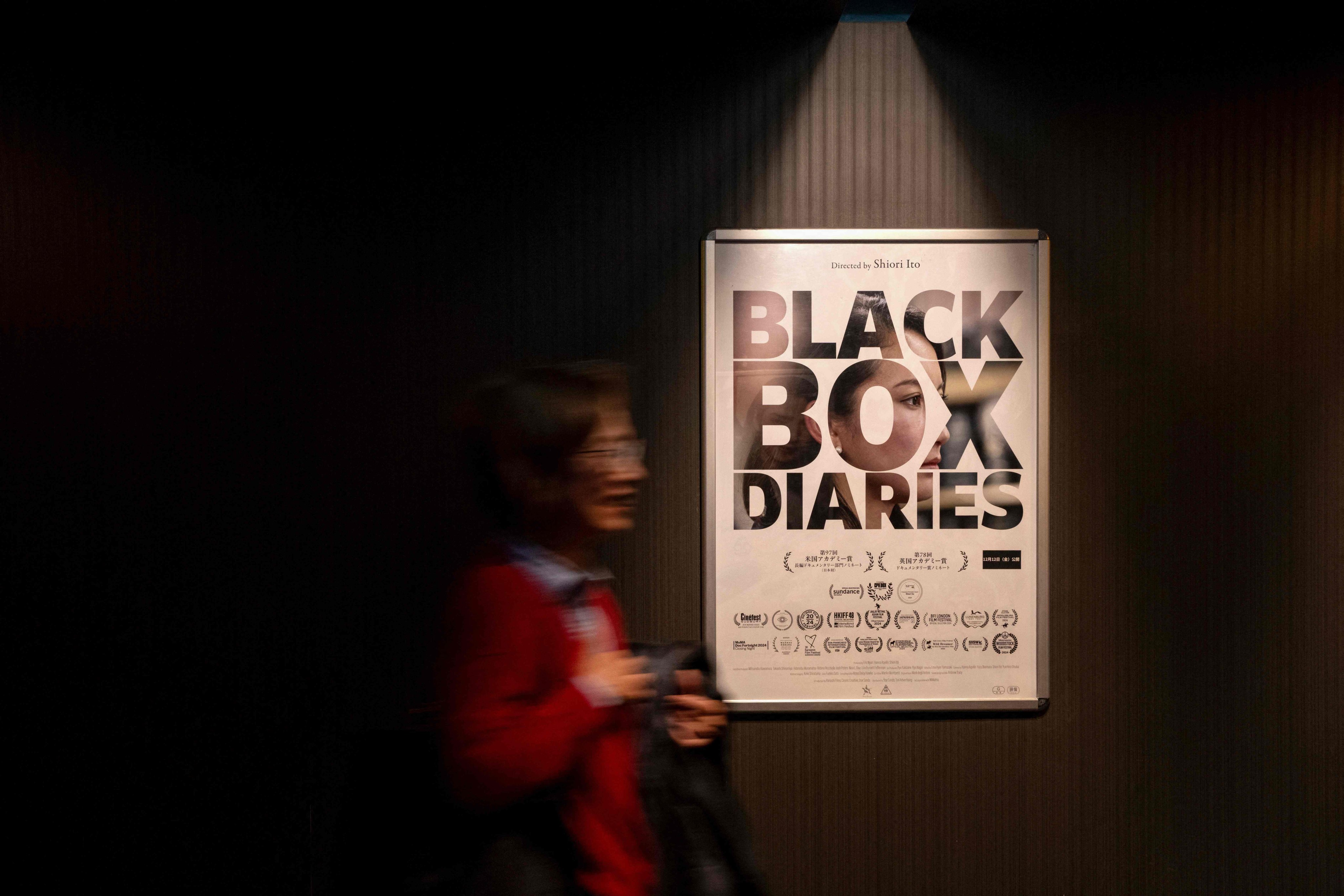 A woman passes a promotional poster for the film “Black Box Diaries” at a Tokyo movie theatre on Friday. Photo: AFP