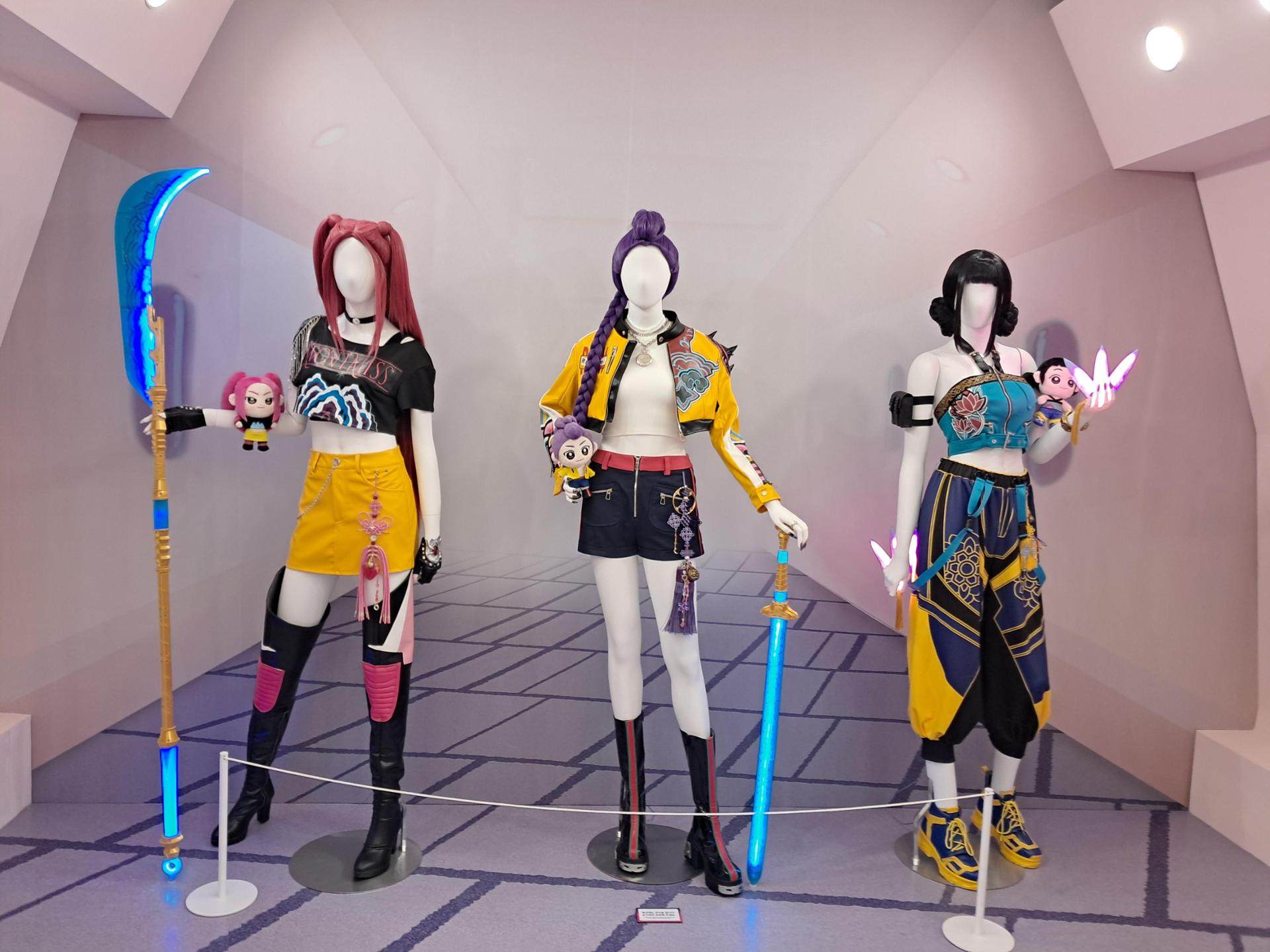 Life-size mannequins display the signature costumes of the girl group Huntrix at a KPop Demon Hunters pop-up in Seoul. Photo: The Korea Times