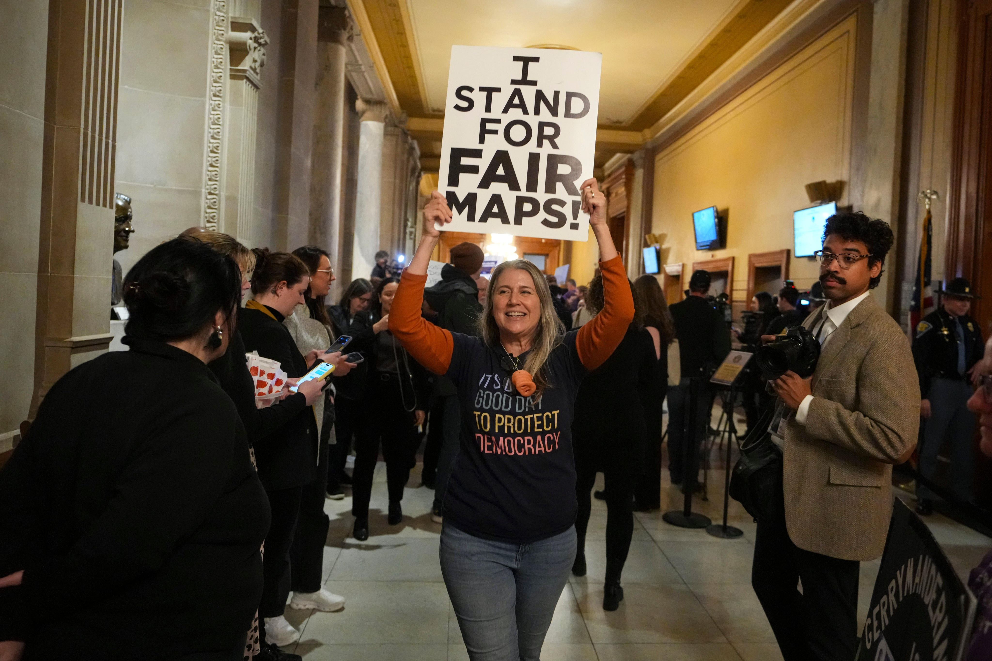 A protester celebrates outside the Indiana Senate Chamber on Thursday. Photo: AP
