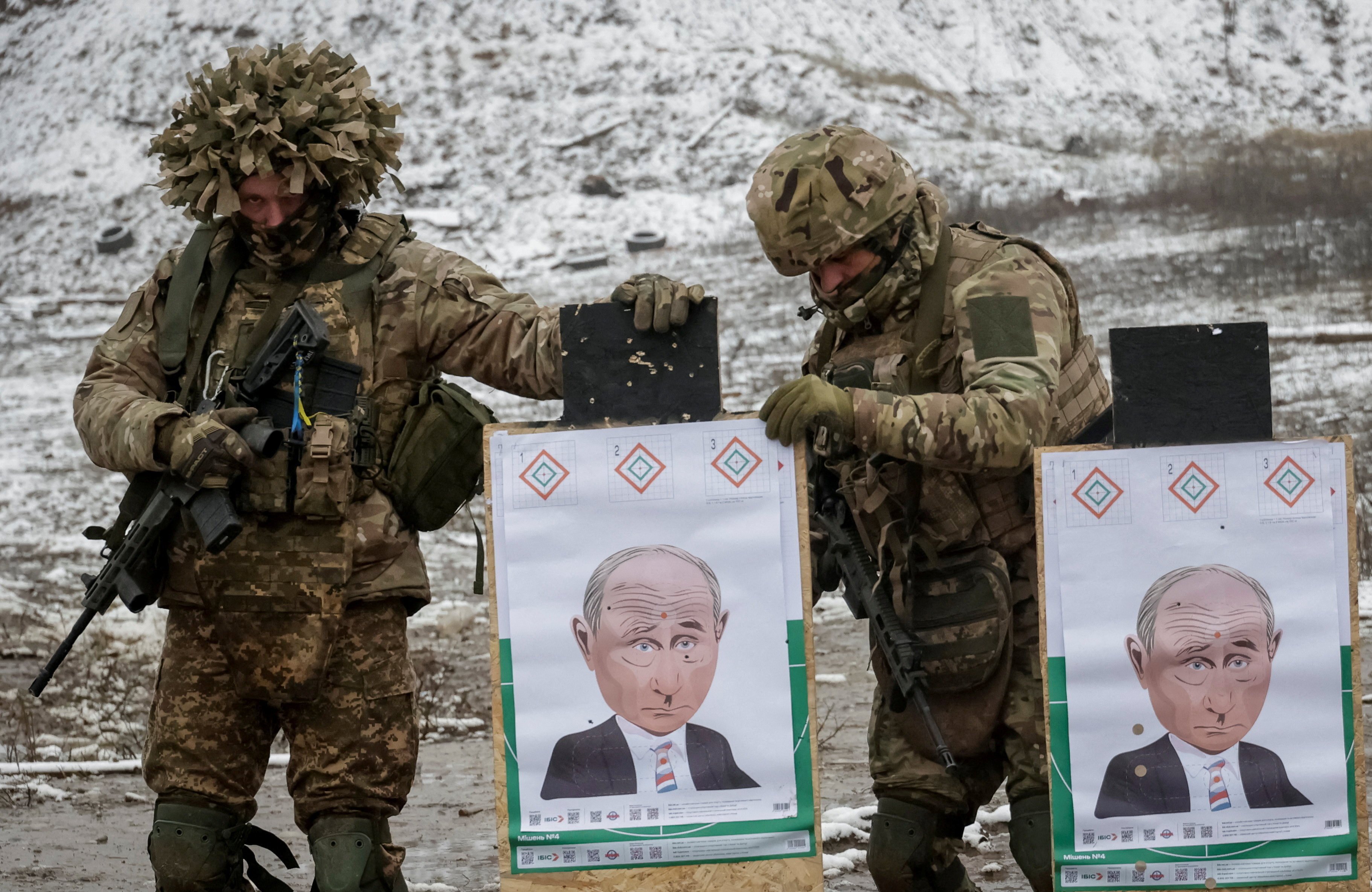 Ukrainian servicemen prepare targets with images depicting Russian President Vladimir Putin during shooting practice between combat missions in the Kharkiv region on Wednesday. Photo: Reuters