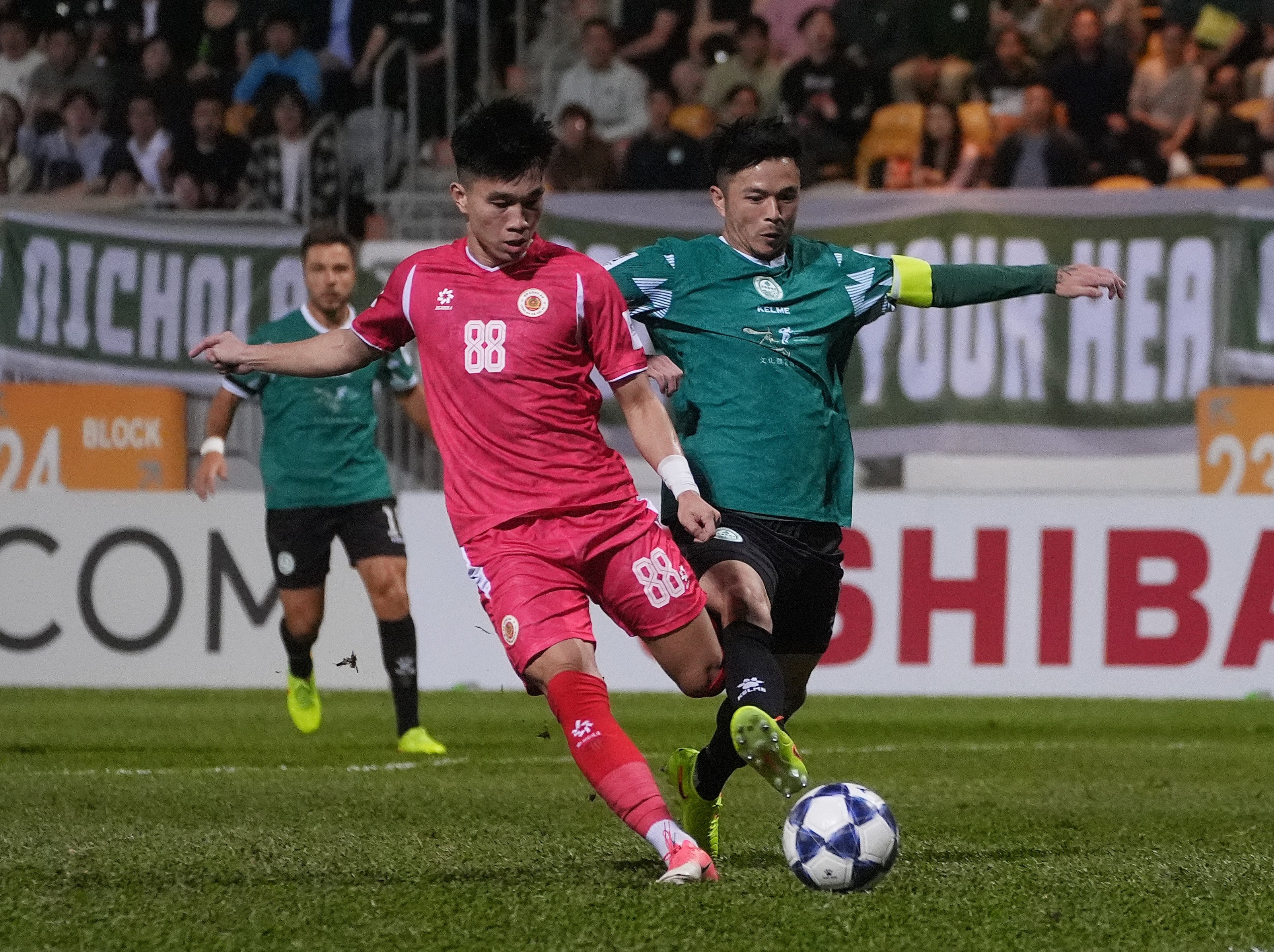 Tai Po’s Philip Chan (right) fights for the ball with Le Van Do at Mong Kok Stadium. Photo: Elson Li