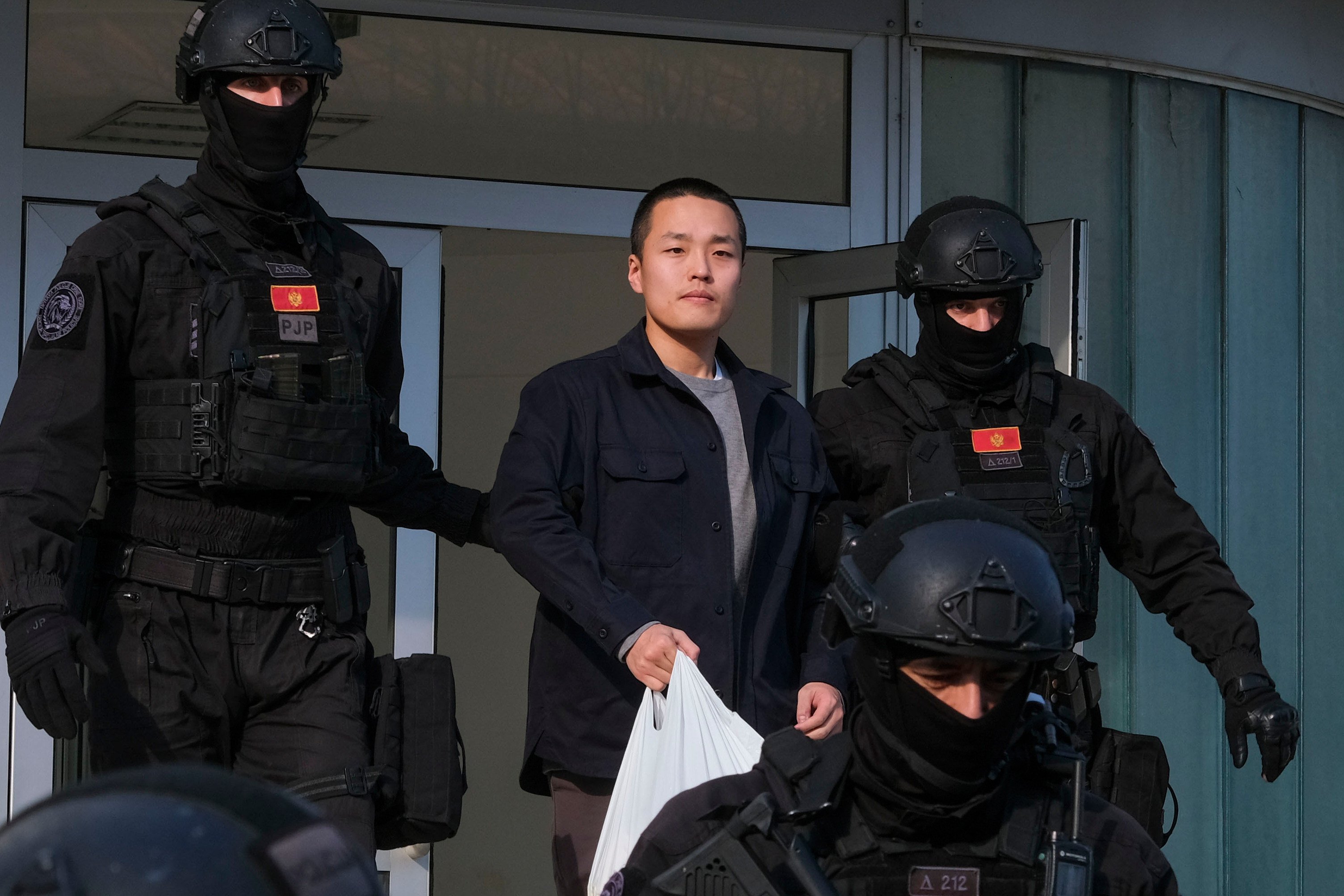 Police officers escort Terraform Labs founder Do Kwon in Montenegro’s capital Podgorica in March 2024. Photo: AP