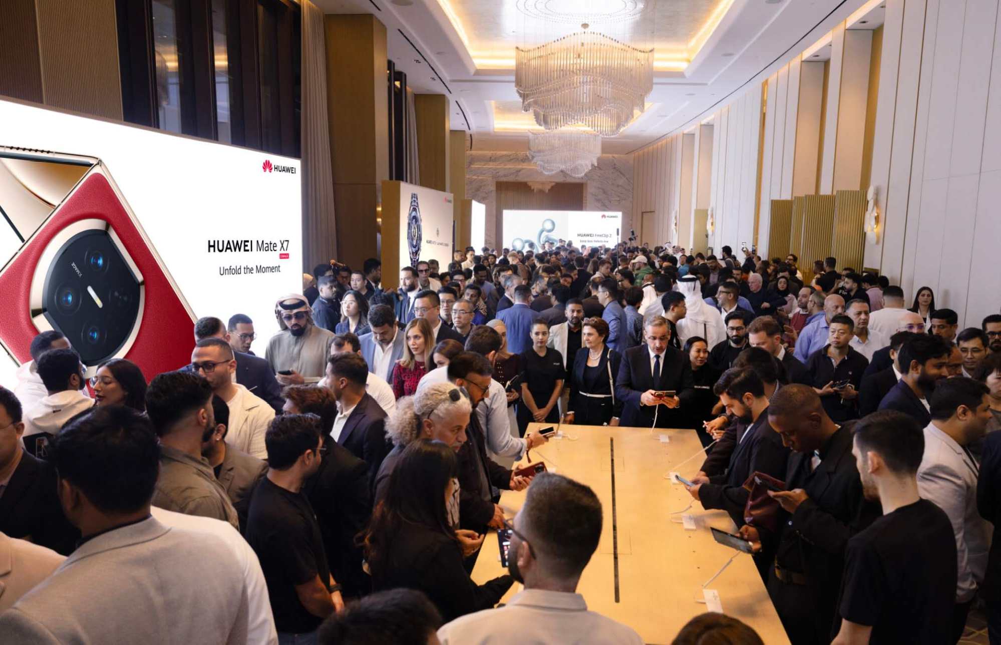 Visitors try the Huawei Mate X7 foldable phone at the launch event in Dubai. Photo: Handout Visitors try the Huawei Mate X7 foldable phone at the launch event in Dubai. Photo: Handout