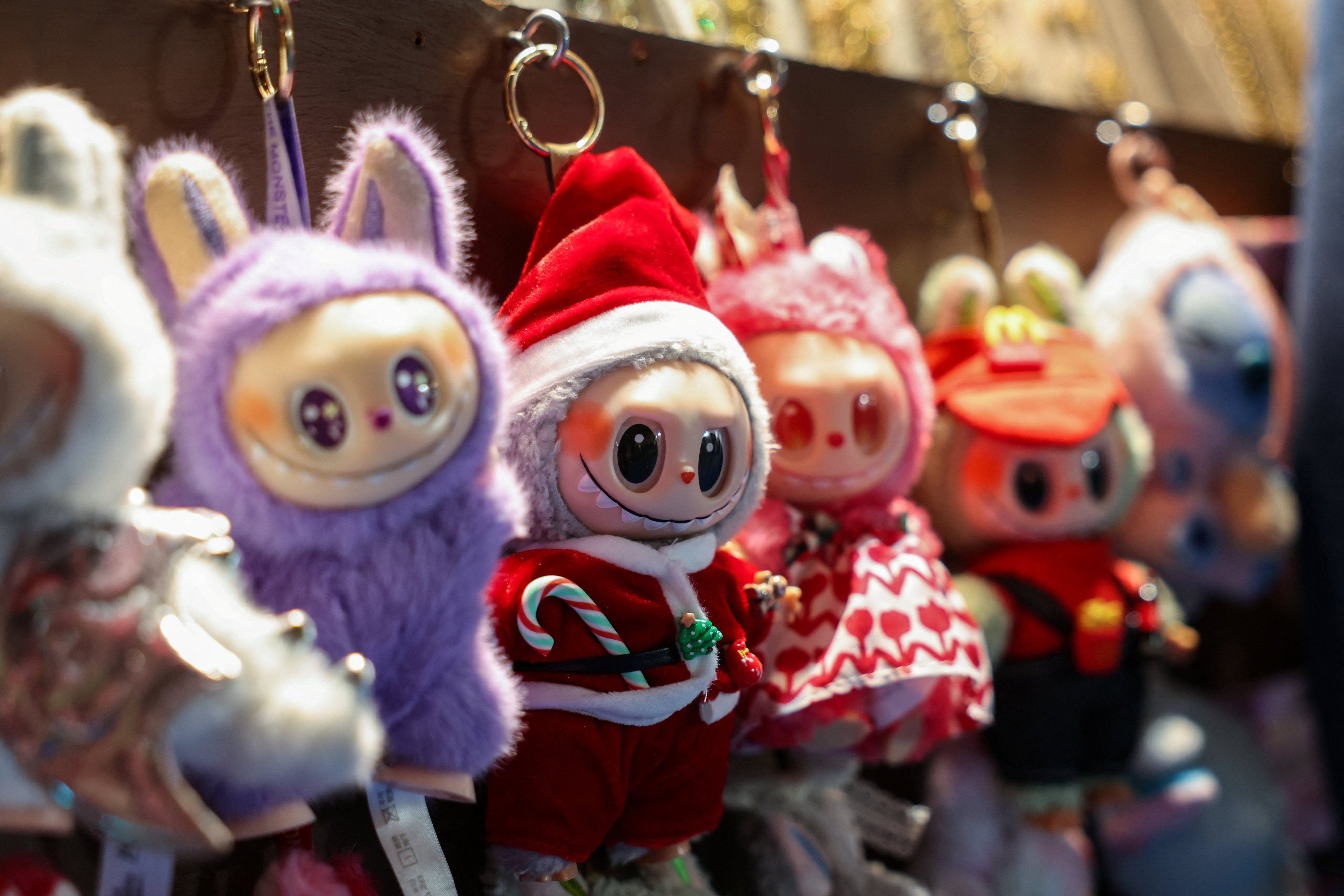 Labubus hang for sale at a market in New York’s Times Square in November 2025. The dolls’ unprecedented popularity has led their value to surge as many buy them as investments and keep them entombed in plastic cases. Photo: Reuters