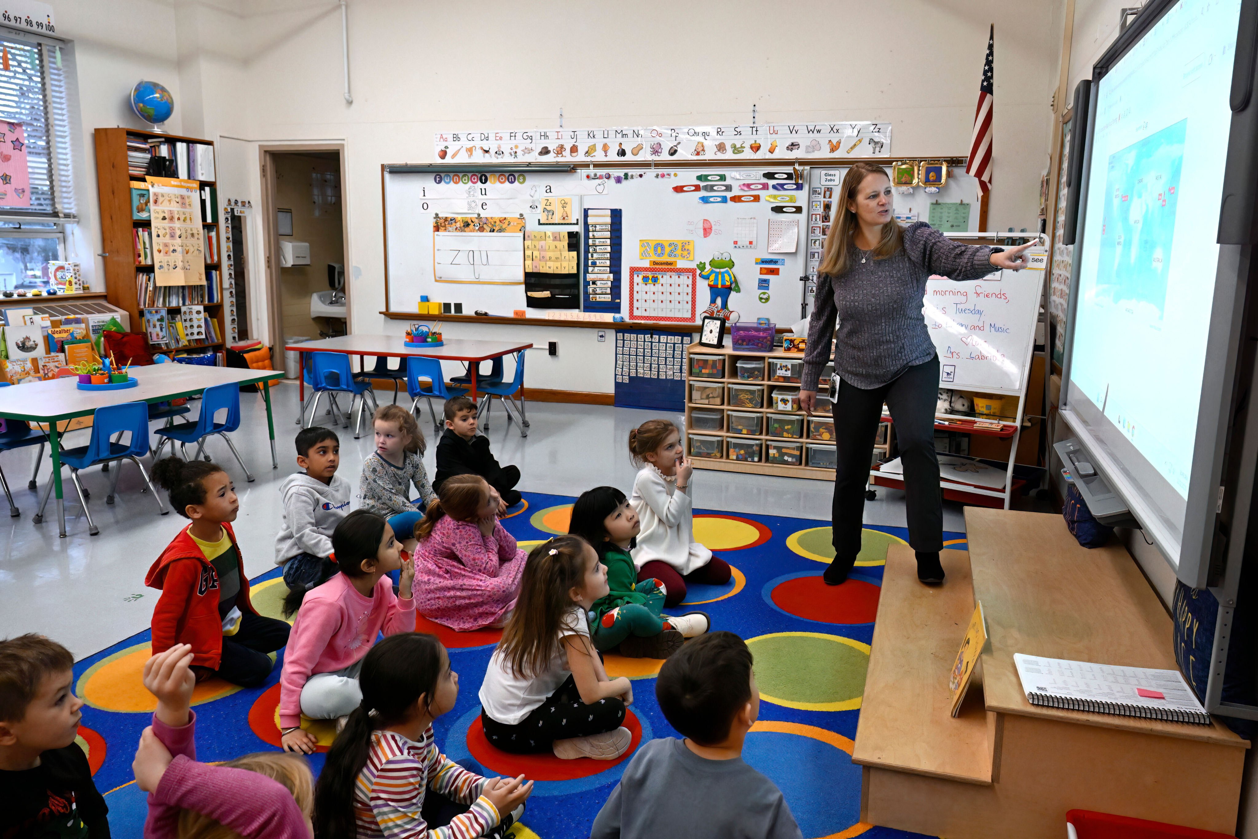 Webster Hill Elementary School teacher Christin Labriola points out countries on a map during a lesson incorporating Asian-American and Pacific Islander subjects on December 2. Photo: AP