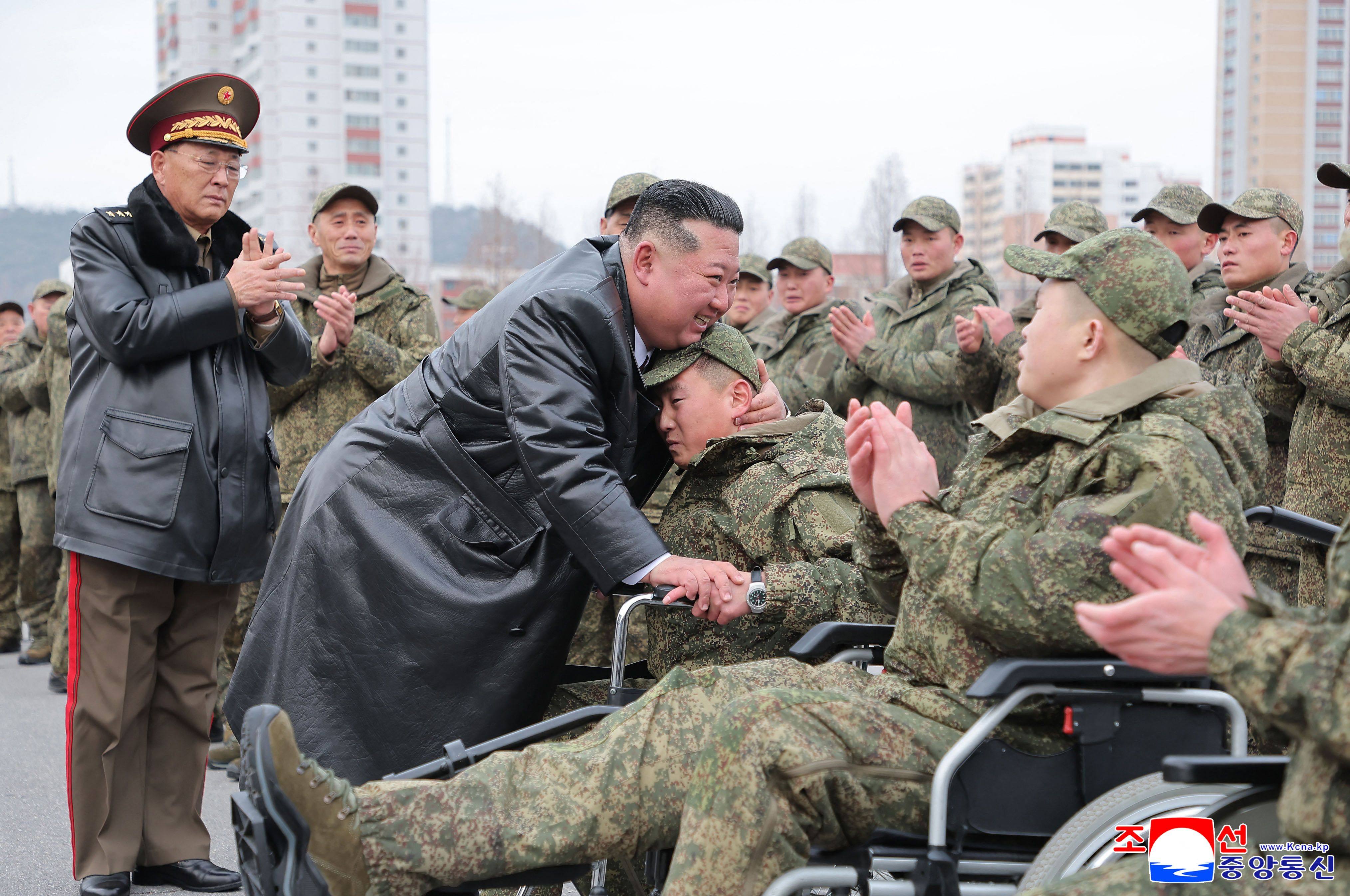 North Korean leader Kim Jong-un hugs a soldier from the Korean People’s Army’s 528th Regiment of Engineers in a photo released on Saturday. Photo: KCNA/AFP