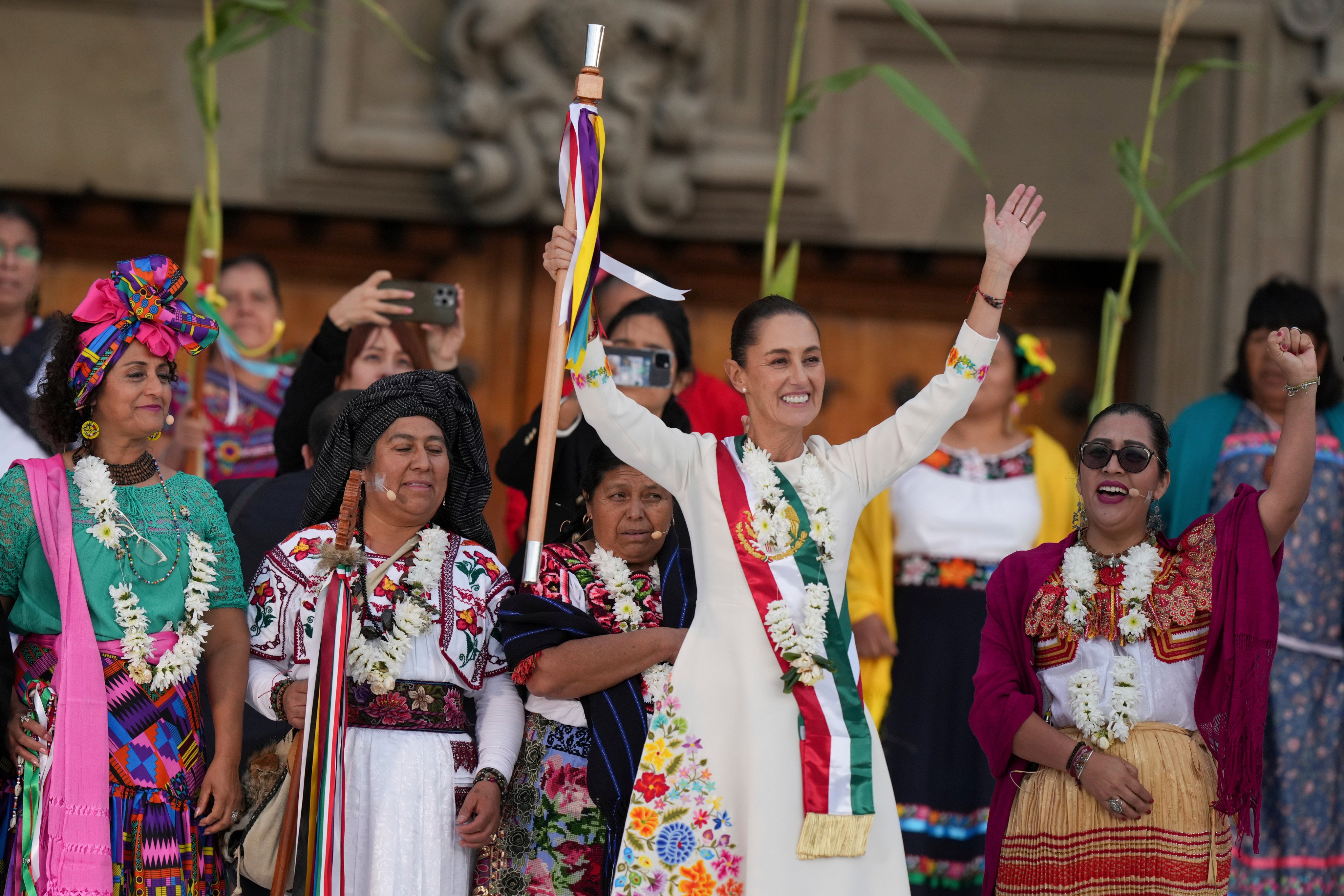 Mexican President Claudia Sheinbaum waves to supporters in the Zocalo main square on her inauguration day. Photo: AP