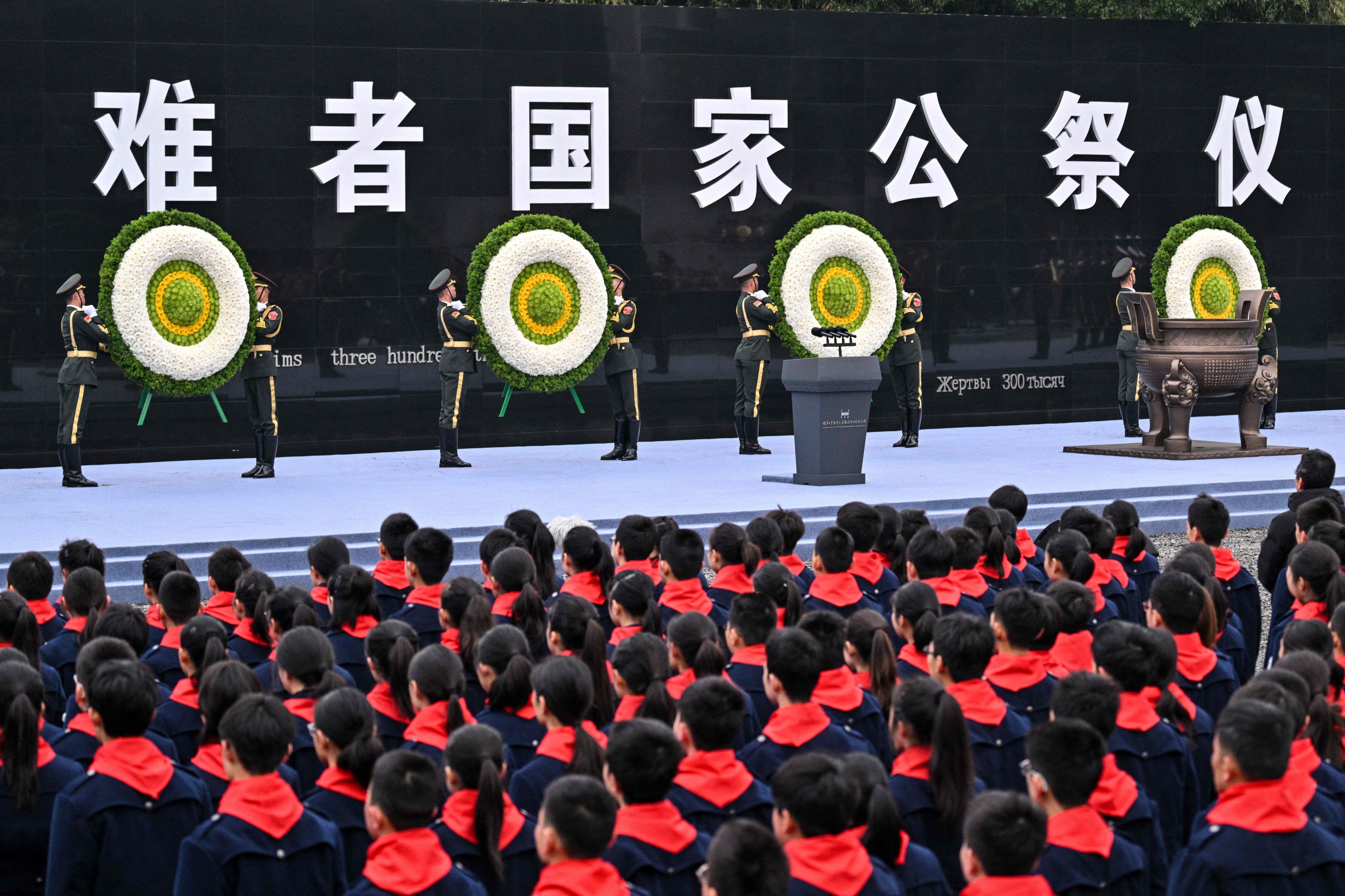 Honour guards place floral tributes during a ceremony to mark the 88th anniversary of the Nanking massacre, in Nanjing in eastern China on Saturday. Photo: AFP