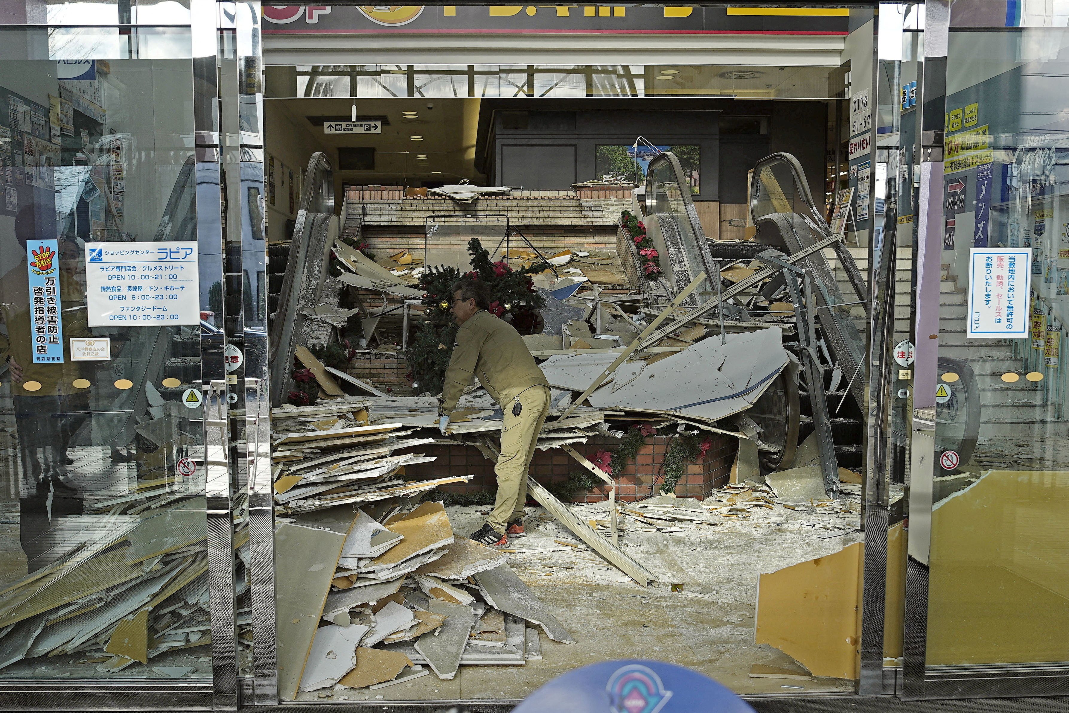 A worker cleans up inside a shopping centre in Hachinohe in Aomori prefecture on Tuesday. Photo: Kyodo/Reuters
