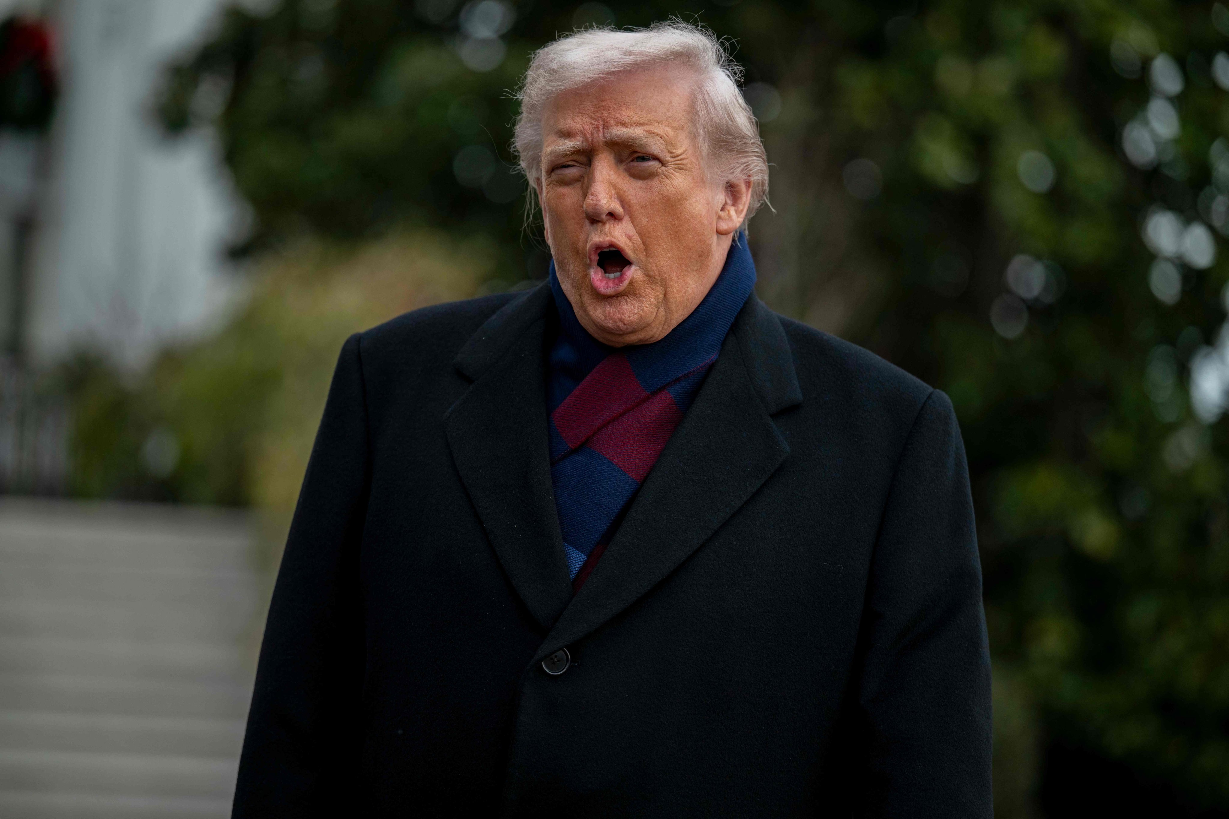 US President Donald Trump talks to the press before boarding Marine One from the South Lawn of the White House on Saturday. Photo: AFP