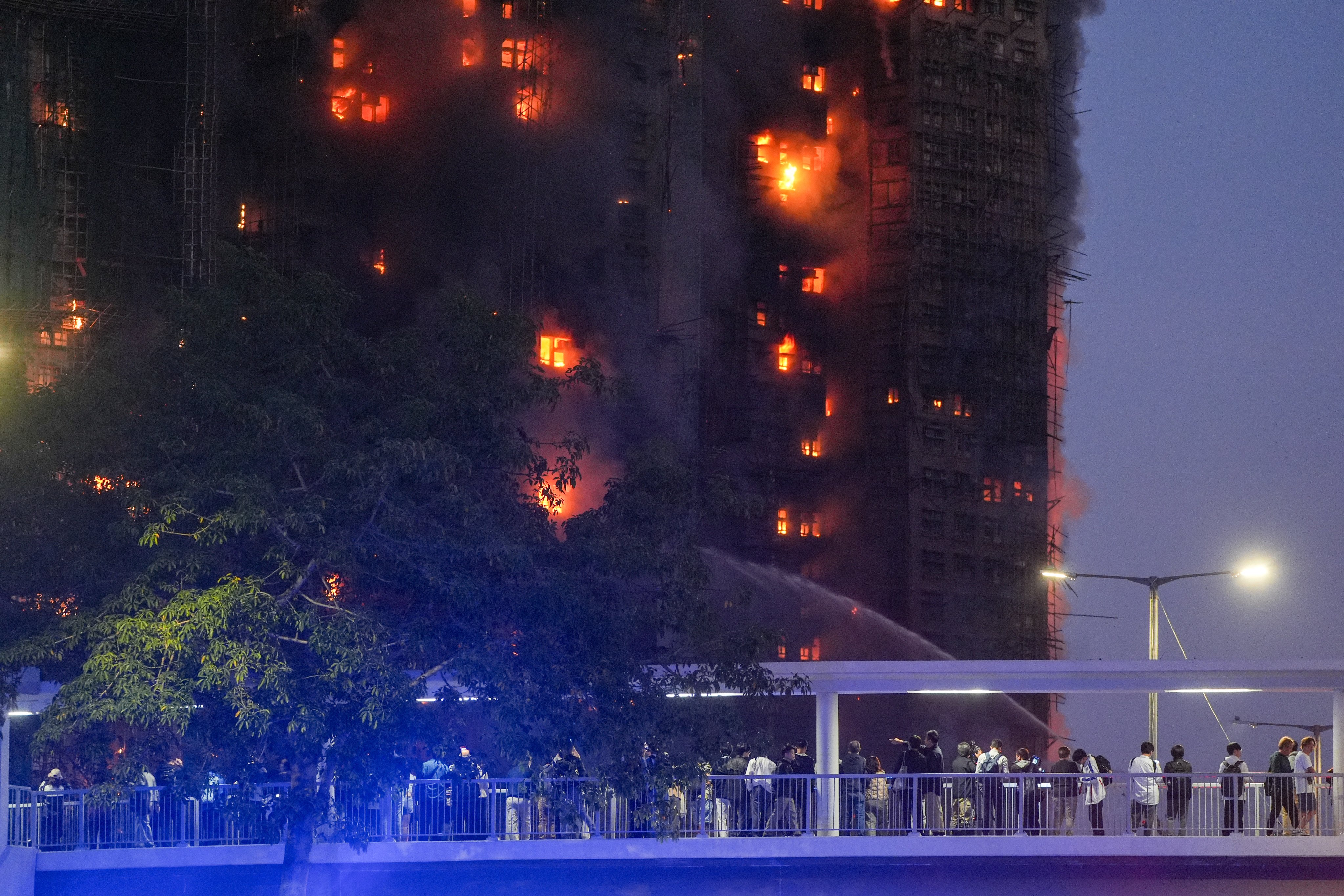 People watch the inferno engulf Wang Fuk Court in Tai Po on November 26. Photo: Eugene Lee