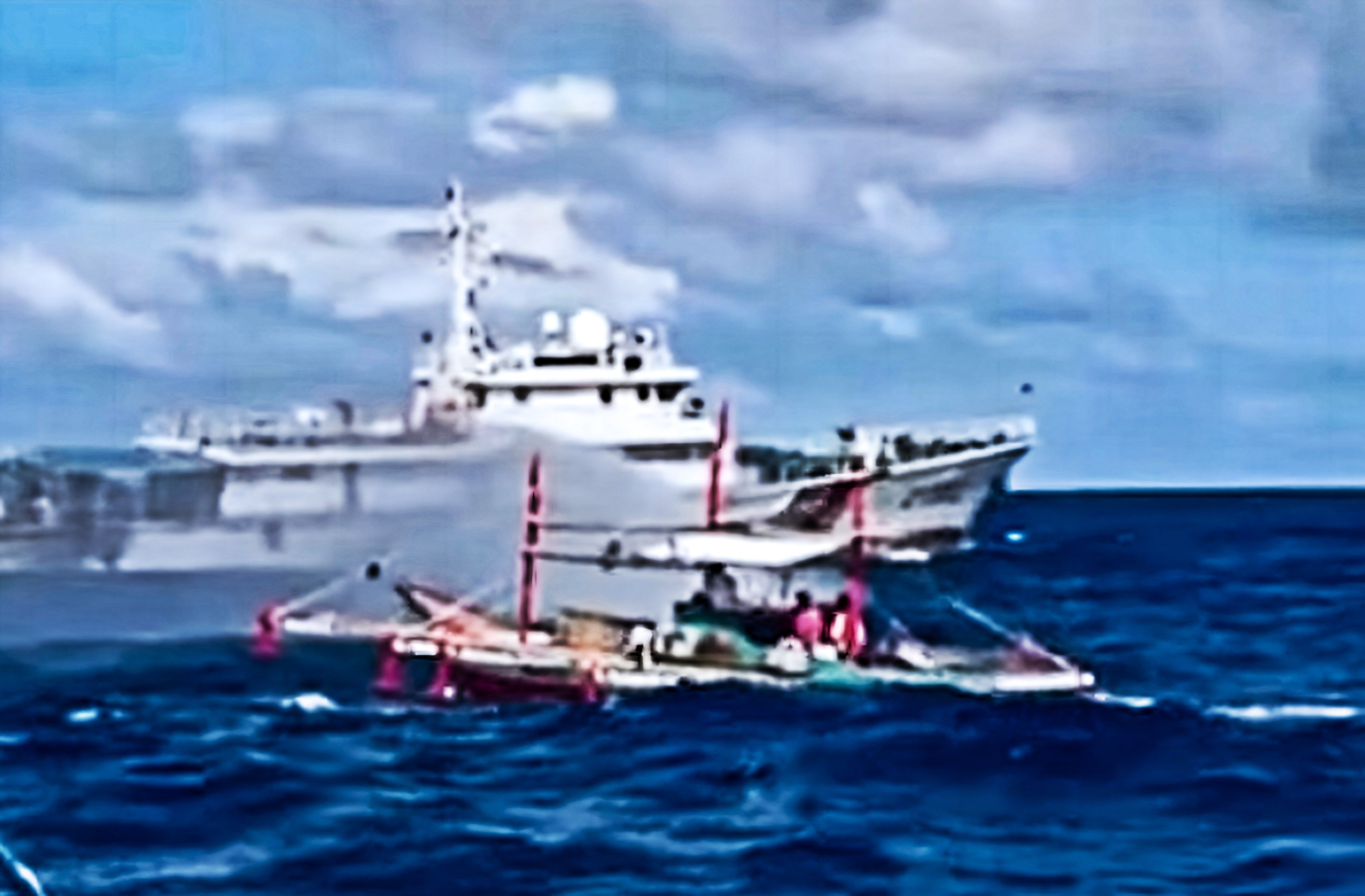 A Chinese coastguard ship is seen deploying a water cannon towards a smaller vessel in a video shared on Saturday by the Philippine coastguard. Photo: Handout