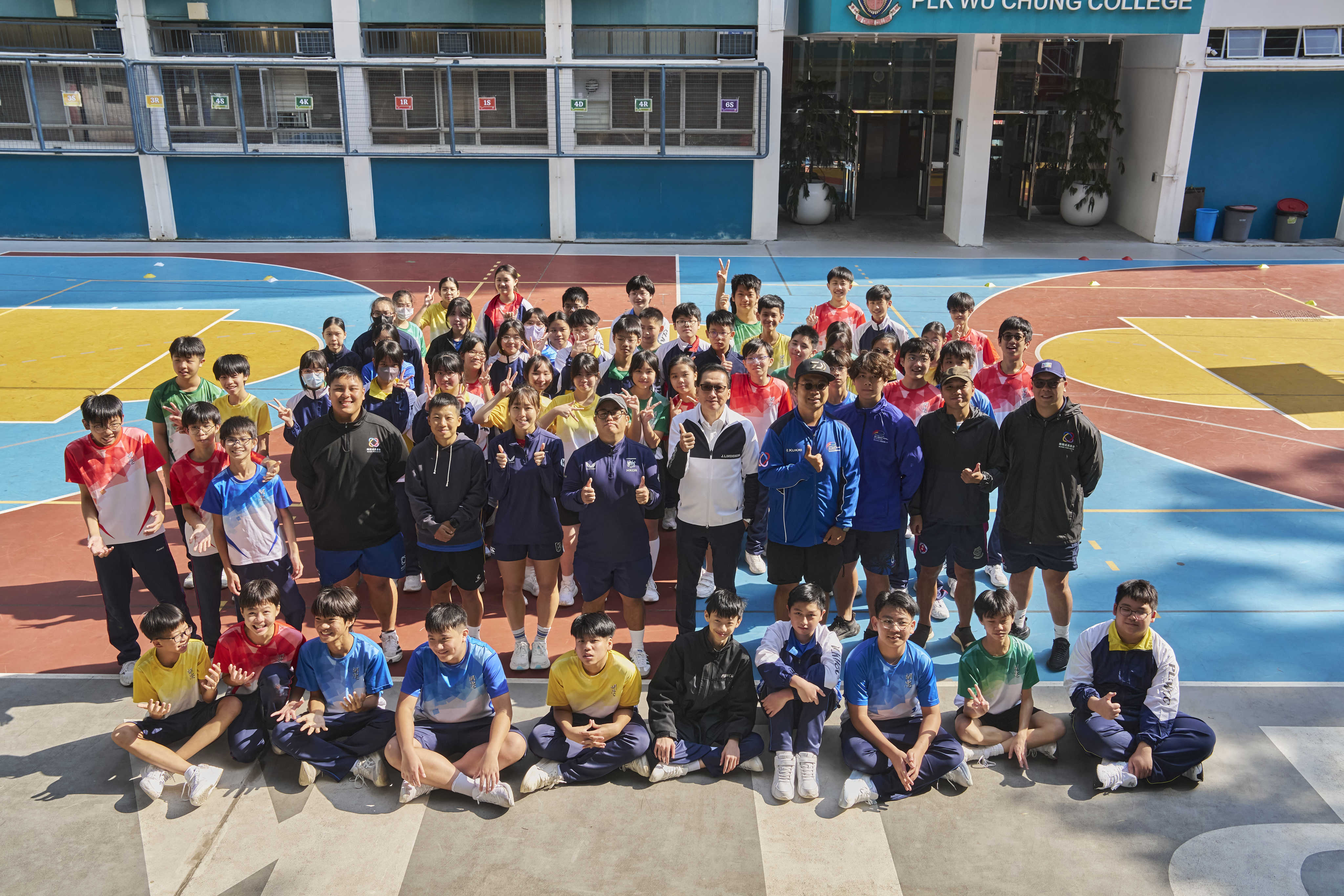 Shaw Foundation chairman Raymond Chan (centre, white top) with students of Poh Leung Kuk Wu Chung College, a recipient of local charity Rugby For Good, which is funded by the foundation and Operation Santa Claus. Photo: Handout