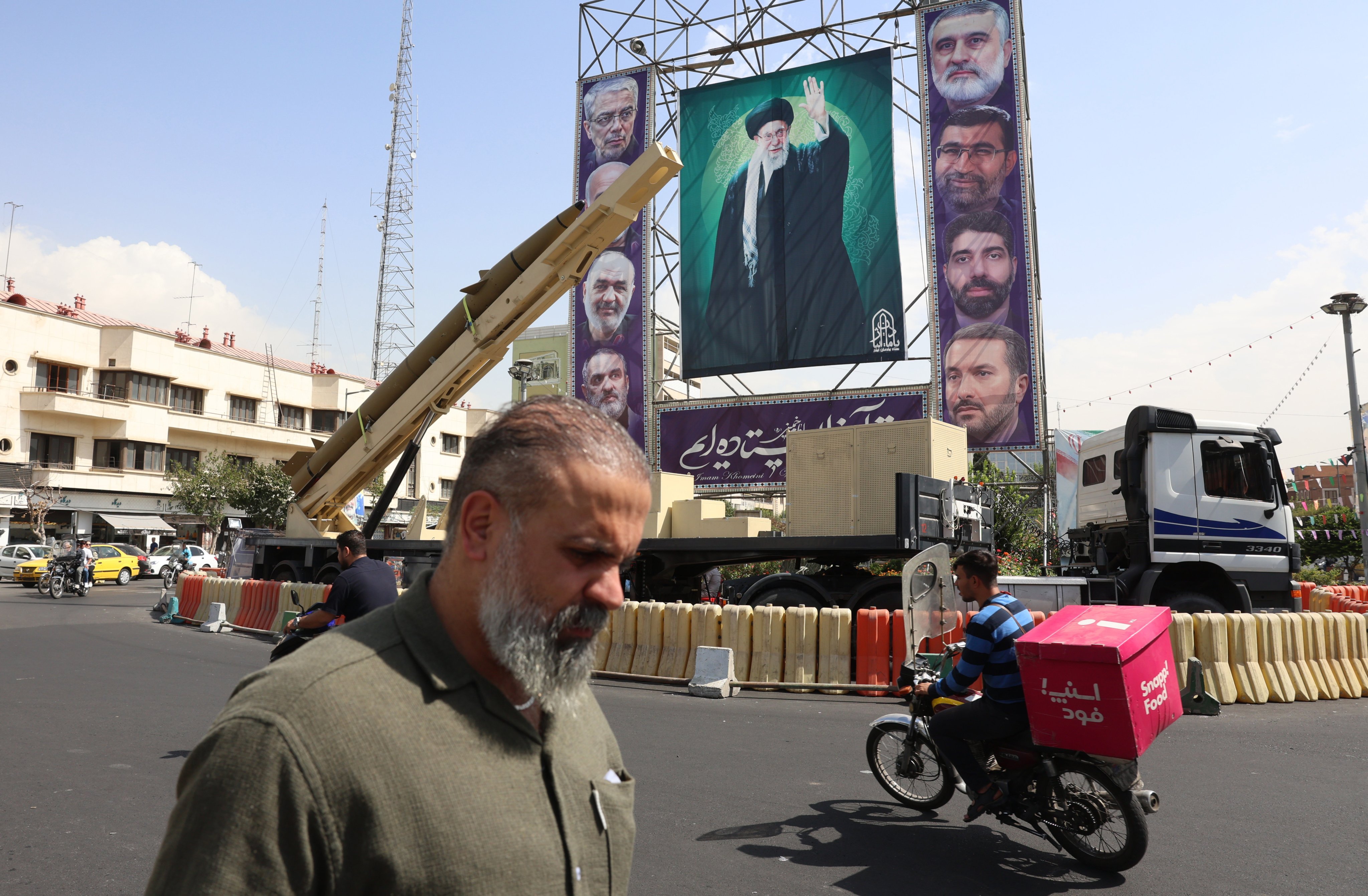 An Iranian medium-range ballistic missile is seen next to a large banner depicting the country’s Supreme leader Ayatollah Ali Khamenei, in the capital Tehran. Photo: EPA