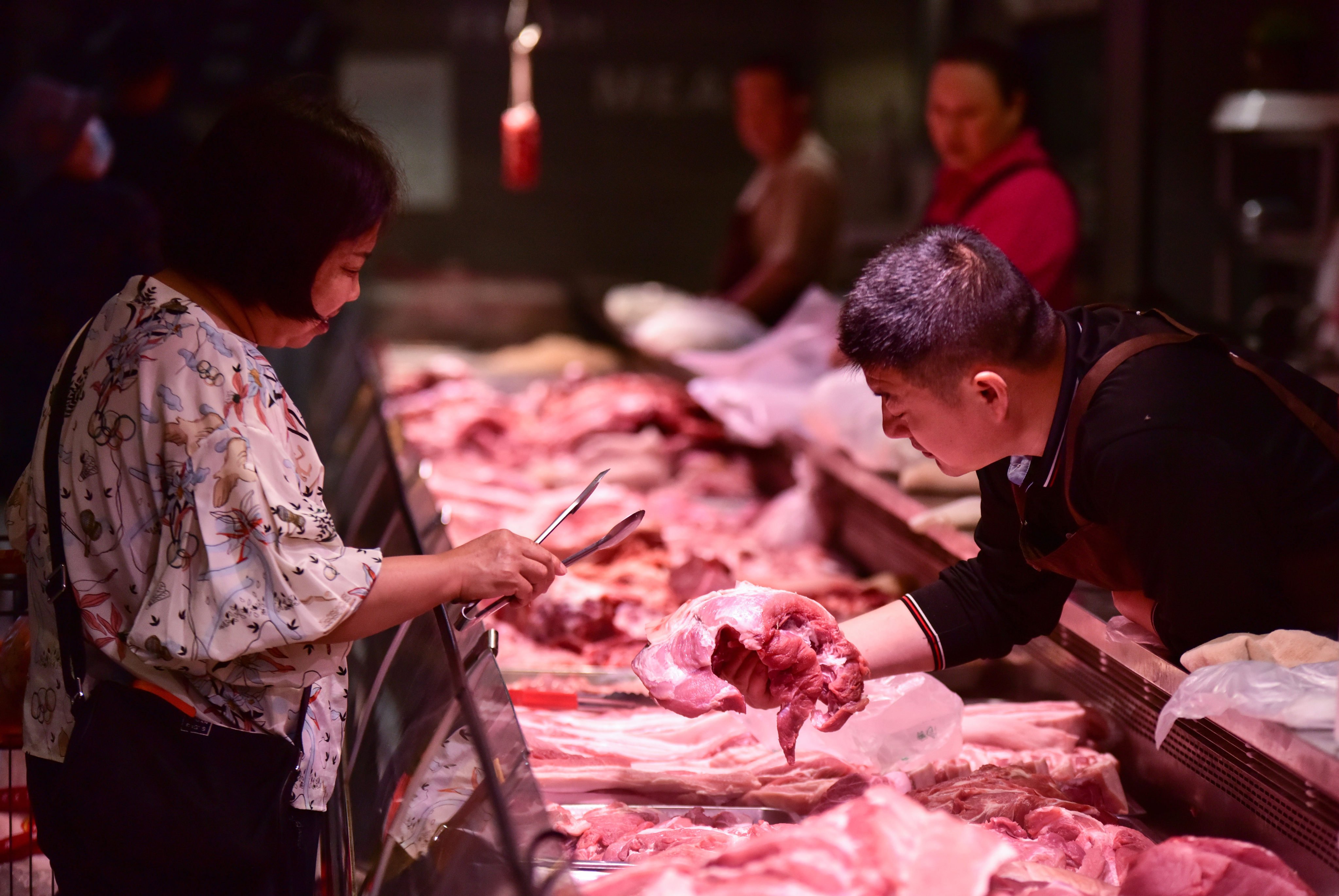 A customer purchases pork at a supermarket in China’s central Anhui province. China is the world’s largest pork consumer. Photo: Getty Images