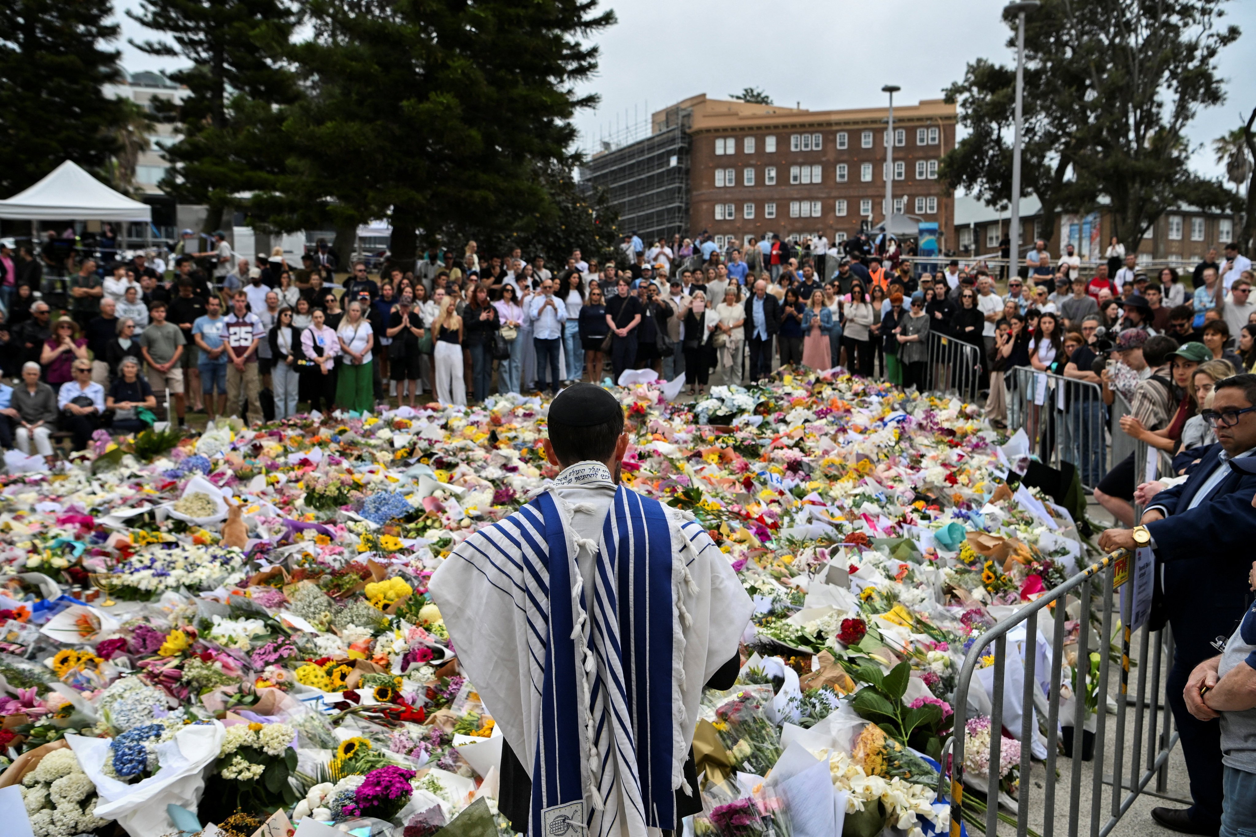 People attend a floral memorial in honour of the Bondi Beach shooting victims in Sydney on Tuesday. Photo: Reuters
