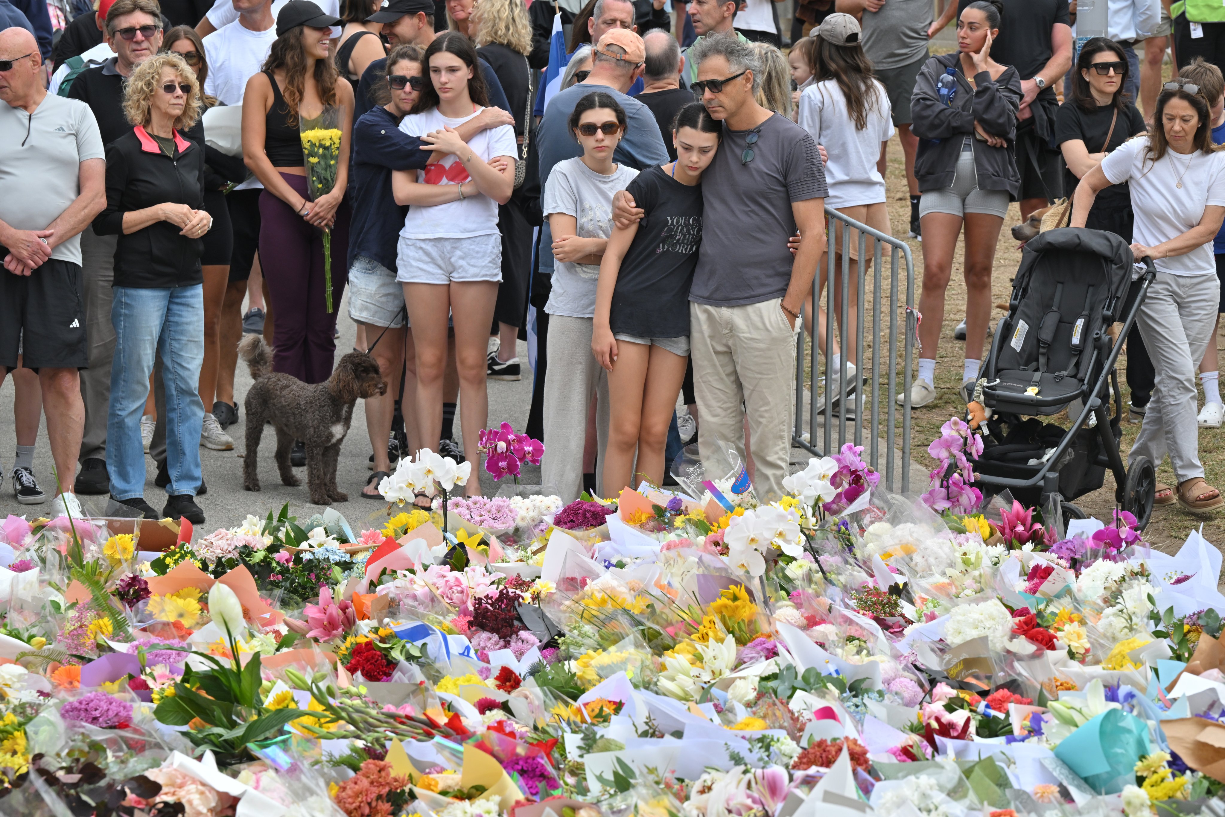 Mourners place flowers at a makeshift memorial at Bondi Beach in Sydney on Tuesday. Photo: EPA