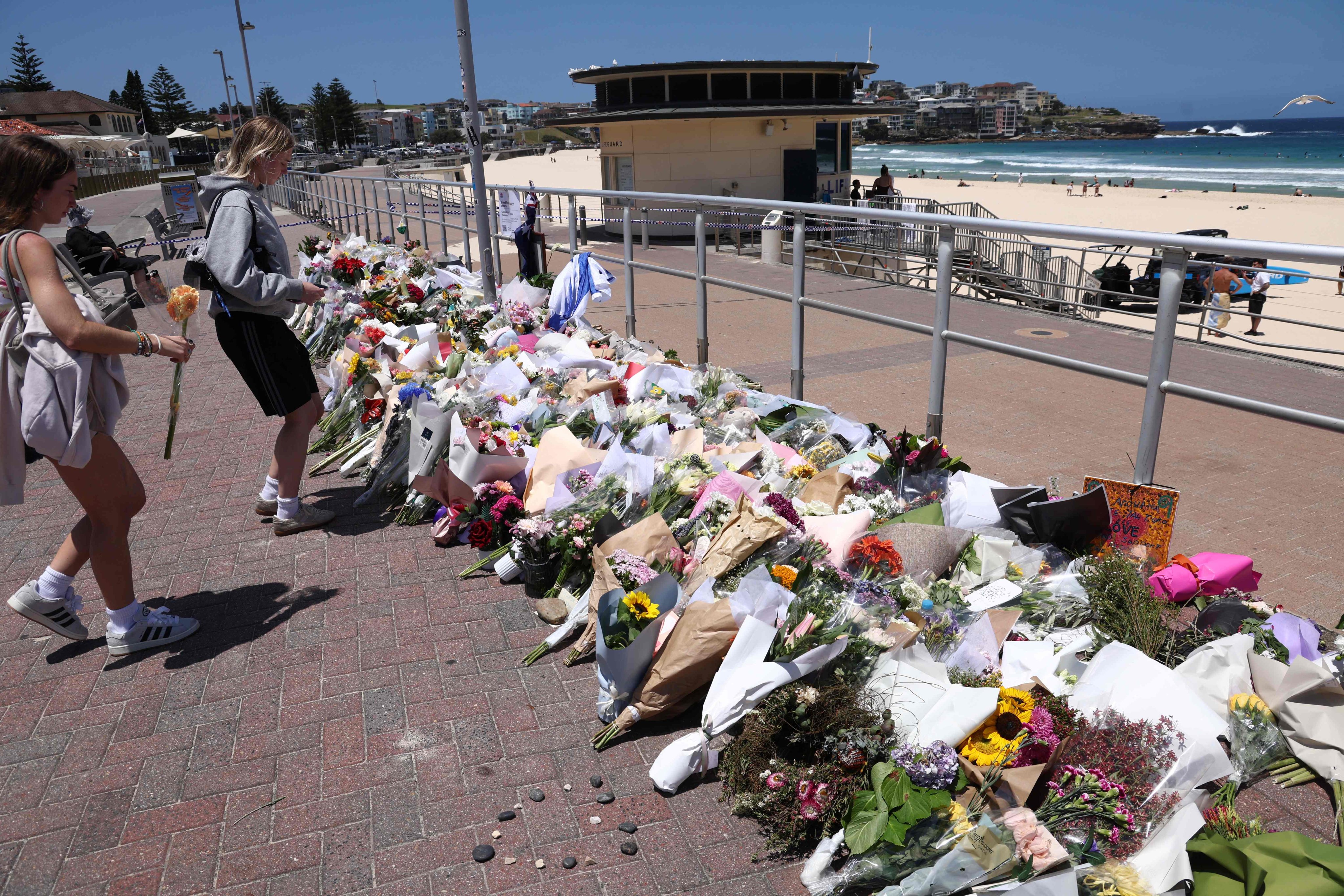 People leave floral tributes at the promenade of Bondi Beach in Sydney on Wednesday. Photo: AFP
