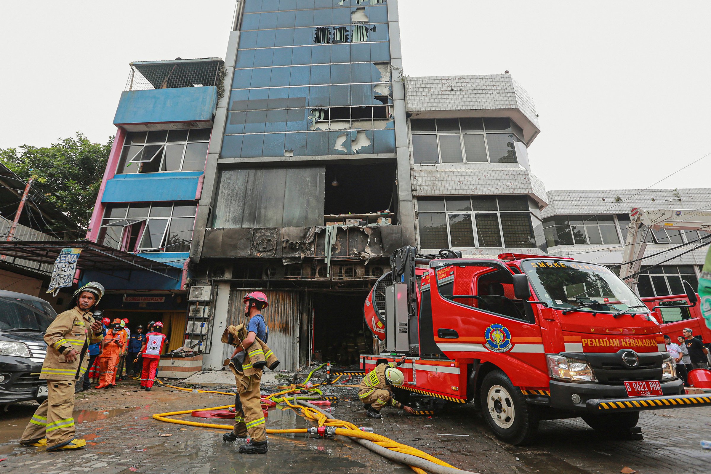 Firefighters at a building in central Jakarta where a fire killed 22 people on December 9. Photo: TNS