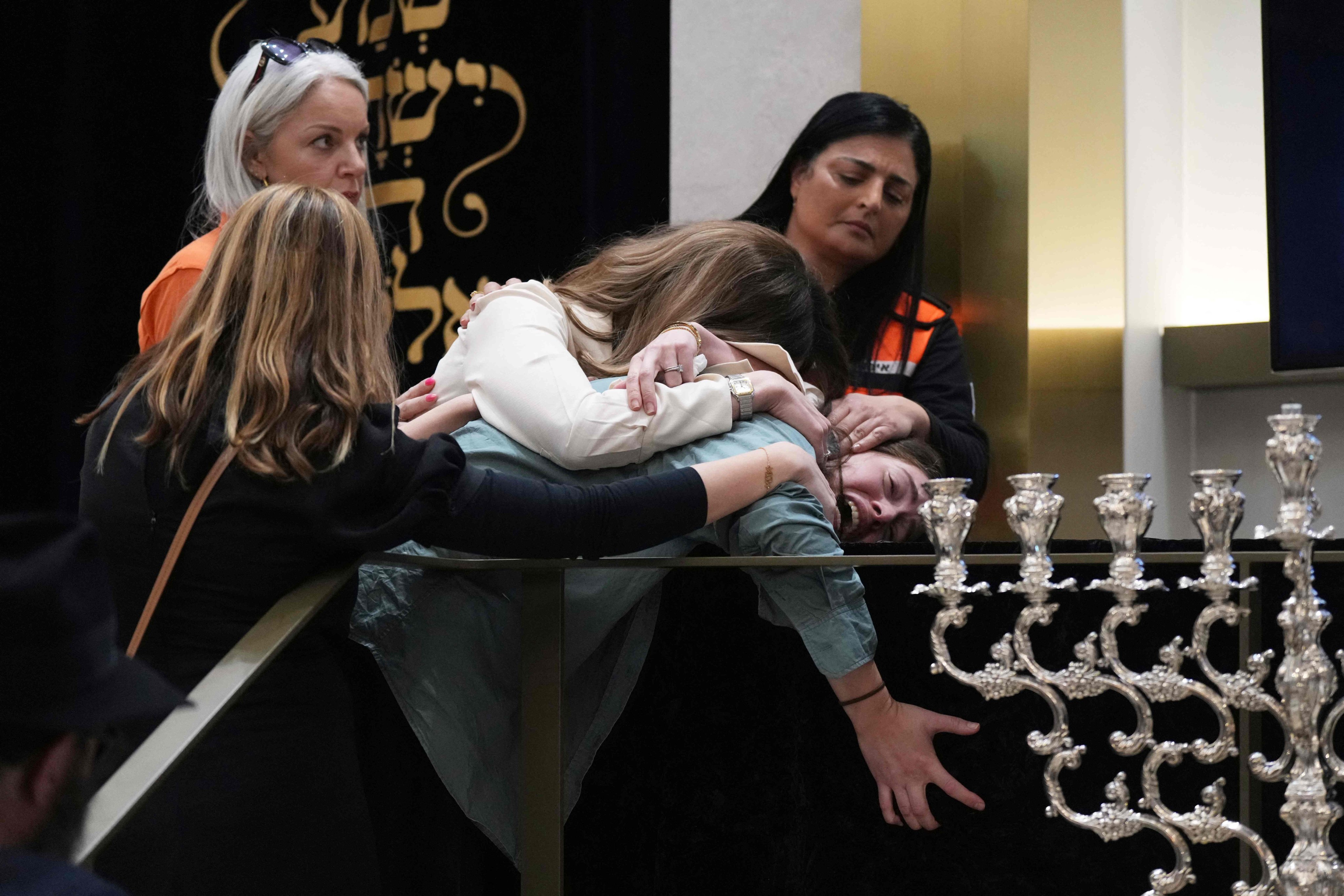 Family members react at the coffin of Rabbi Eli Schlanger, a victim in the Bondi Beach shooting, during his funeral at a synagogue in Sydney on Wednesday. Photo: AFP