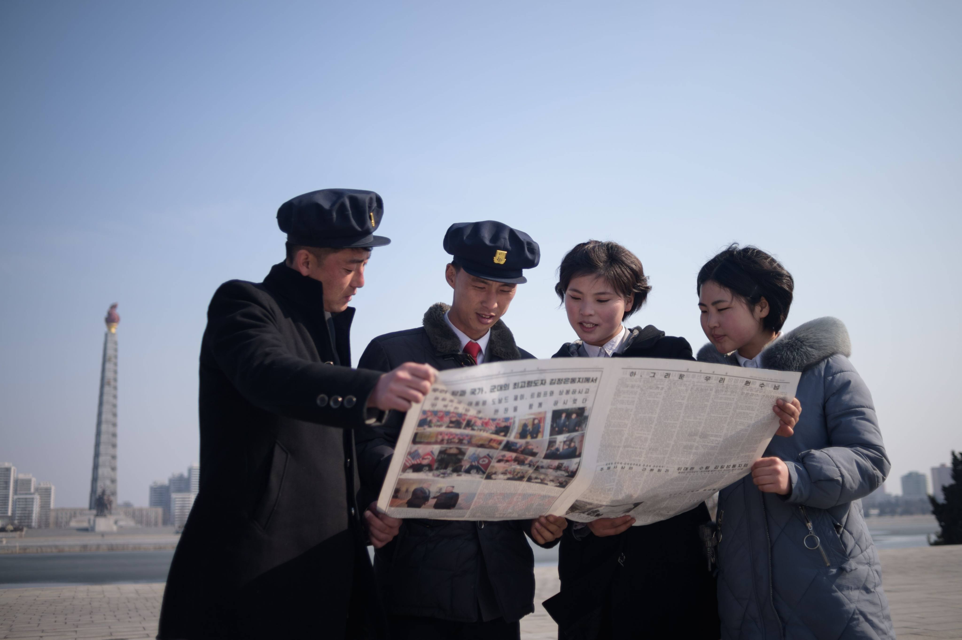 North Korean students read coverage of Kim Jong-un’s Hanoi summit with US President Donald Trump in the Rodong Sinmun newspaper, in Pyongyang, in February 2019. Photo: AFP