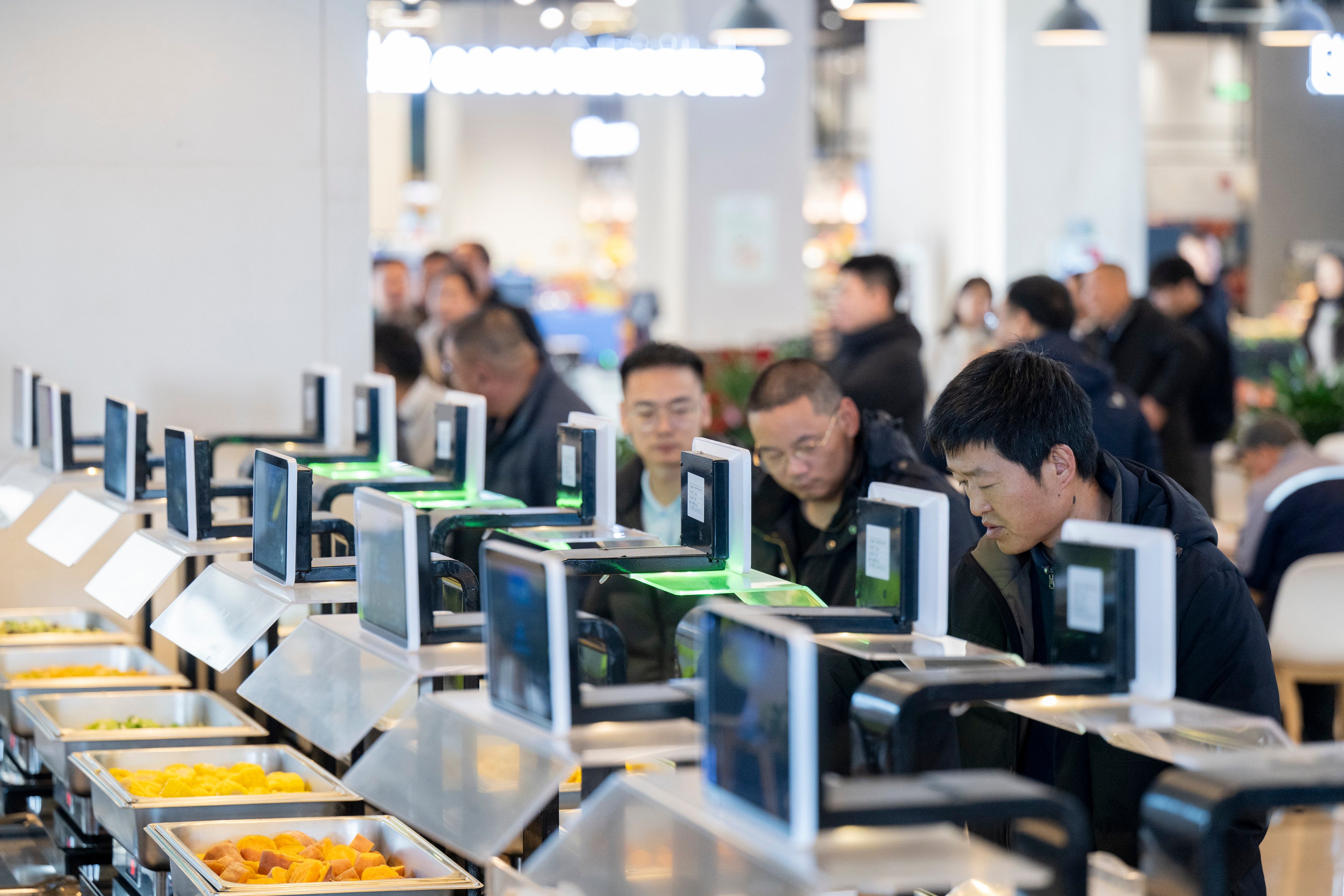 People choose food at an AI-powered canteen in Hebei province’s Xiongan New Area last month. Photo: Xinhua