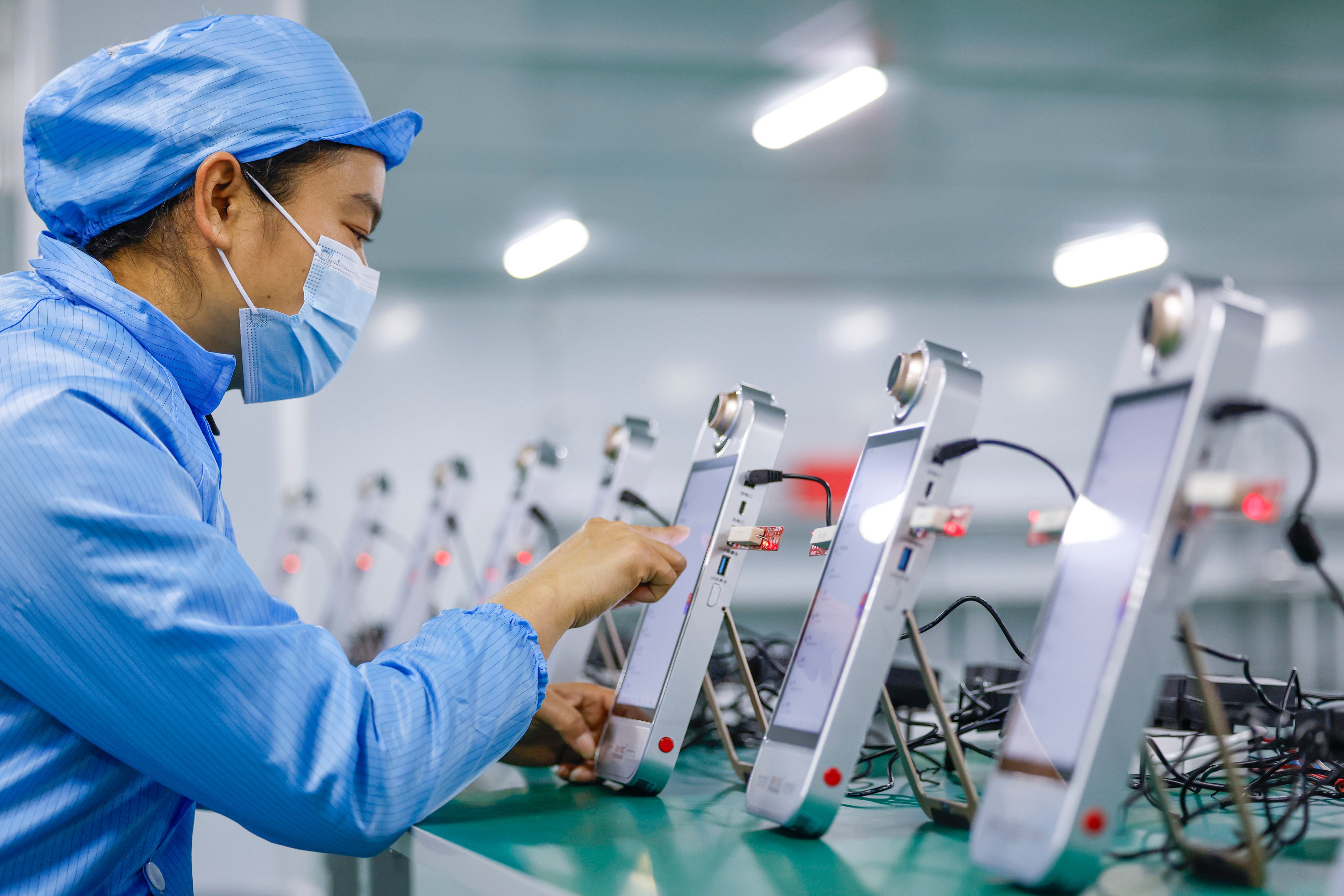 An employee debugs the AI-powered live-streaming machines at a Rexso workshop on December 8 in Huangshan in China’s Anhui province. Photo: VCG via Getty Images