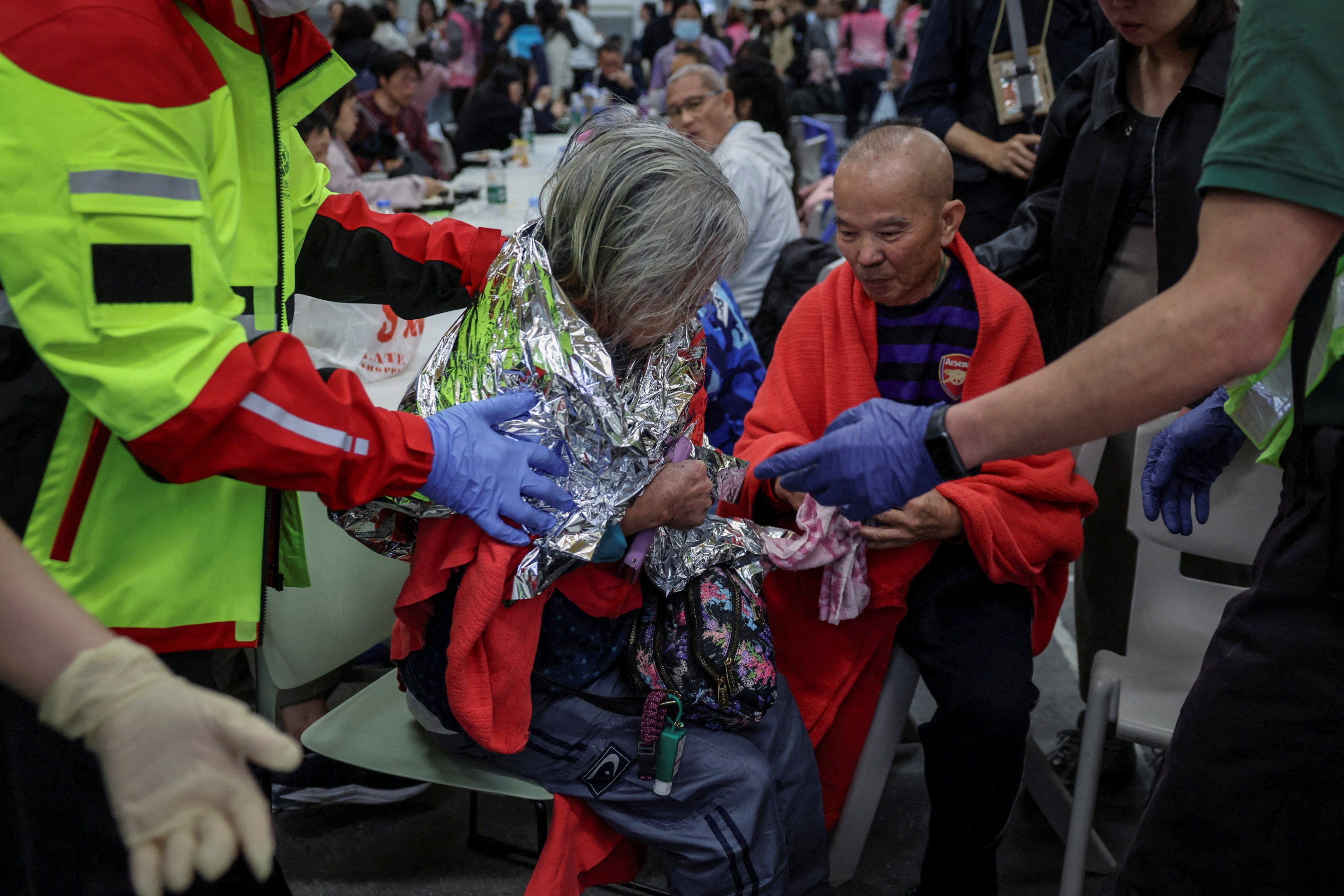 A woman receives medical attention at a temporary shelter, after a fire started across multiple buildings at Wang Fuk Court housing estate in Hong Kong’s Tai Po district on November 26. Photo: Reuters