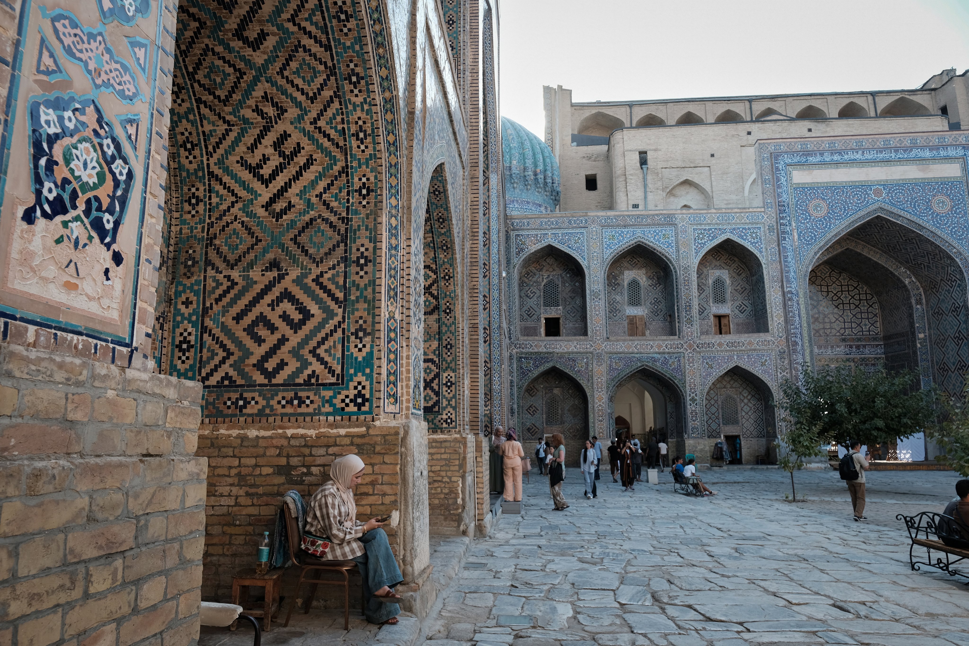 Vendors sell traditional Uzbek clothing and jewellery inside a madrasah in Registan Square in Samarkand, Uzbekistan on September  11. Photo: EPA