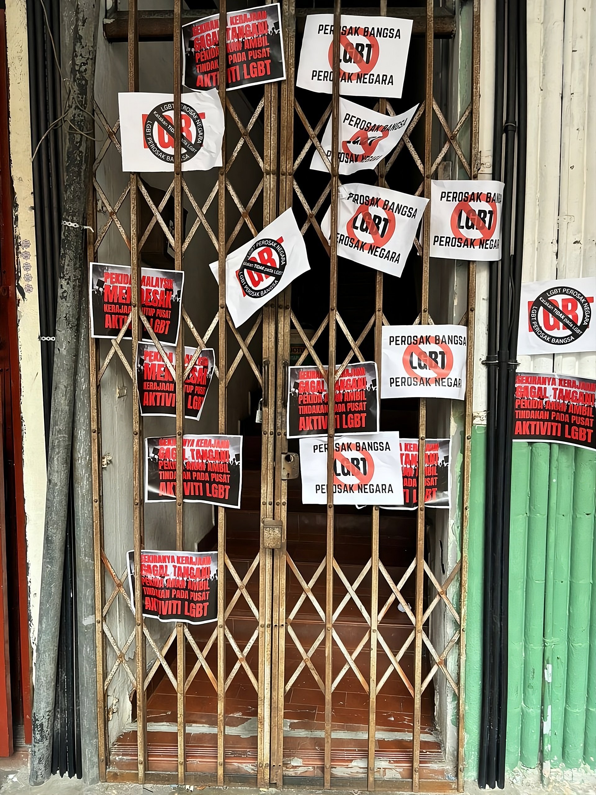 ‘Anti-LGBT’ and ‘nation destroyer’ stickers are seen plastered outside the entrance of a men’s only spa in Chow Kit, Kuala Lumpur, by a Malay nationalist group after the venue was raided by police in November. Photo: Facebook/pekidamalaysiarasmi