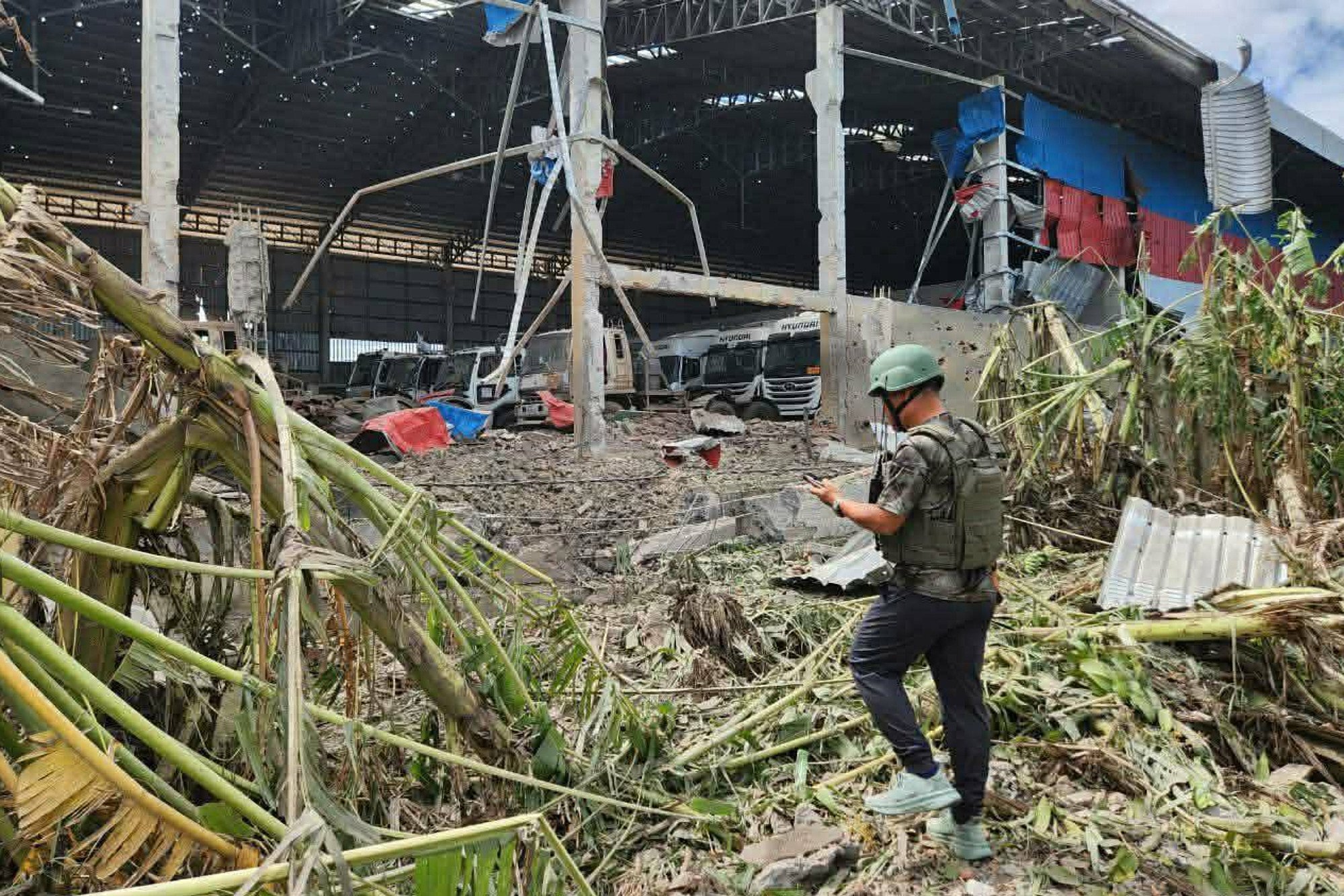 A man inspects a building destroyed by Thai bombing in Poipet town, Banteay Meanchey province, Cambodia, on Thursday. Photo: AKP/AP