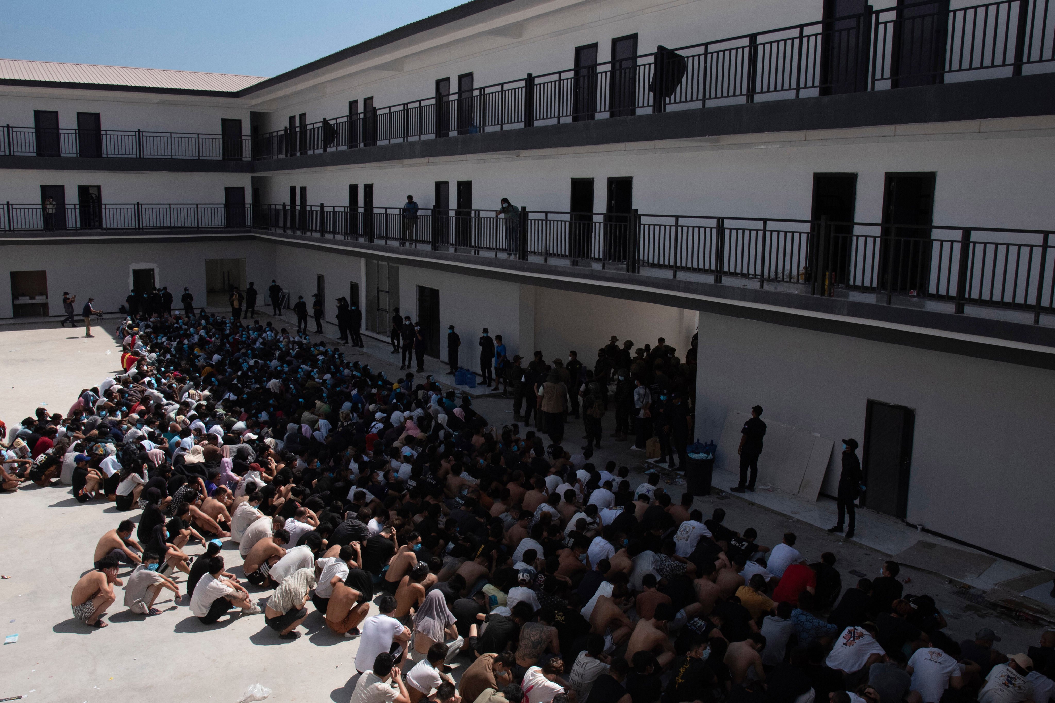 People from China, Vietnam, and Ethiopia – believed trafficked and forced to work in scam centers – sit masked in detention after their February release in Myawaddy, eastern Myanmar. Photo: AP