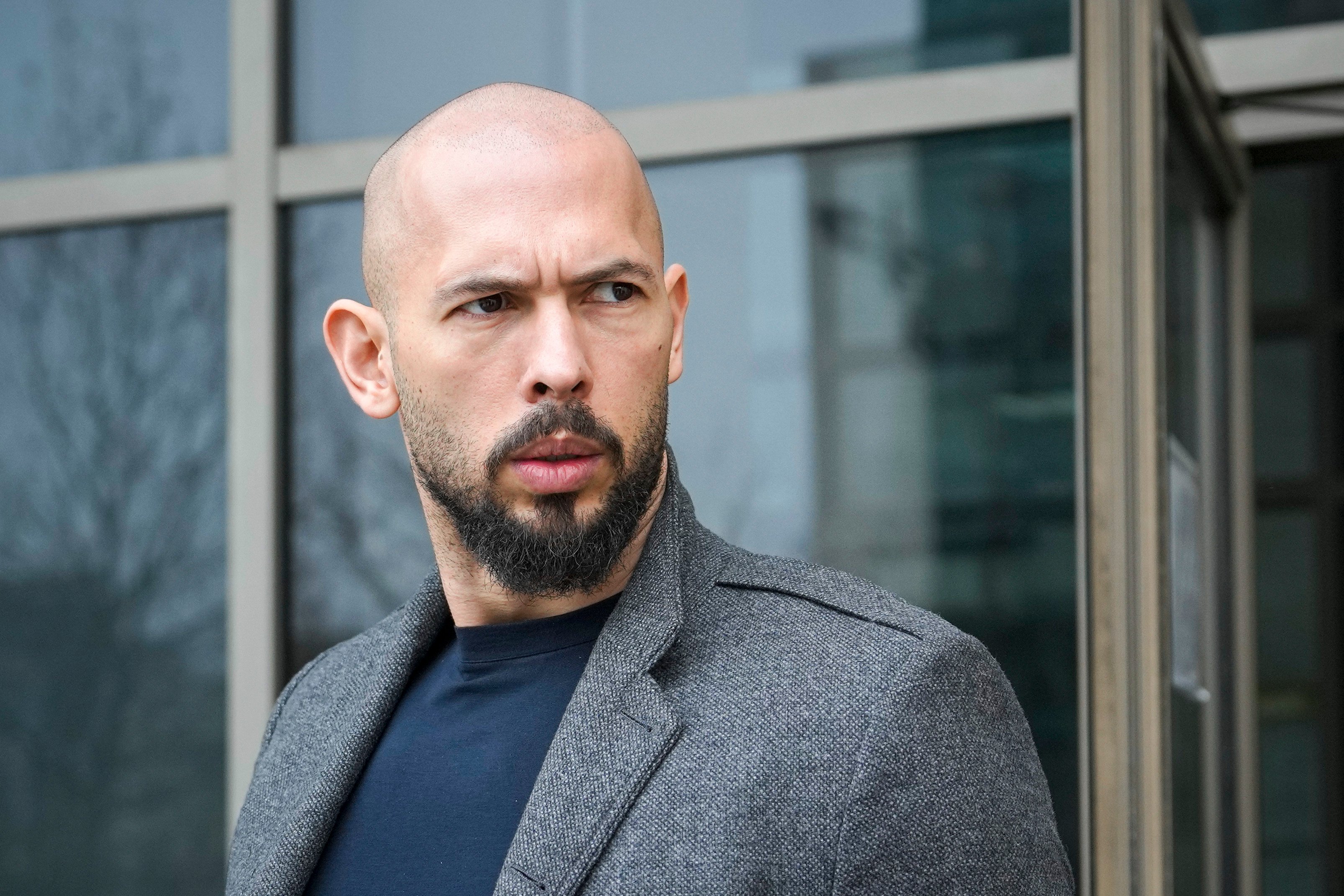 Andrew Tate leaves the Bucharest Tribunal in Romania in February 2024. Photo: AP