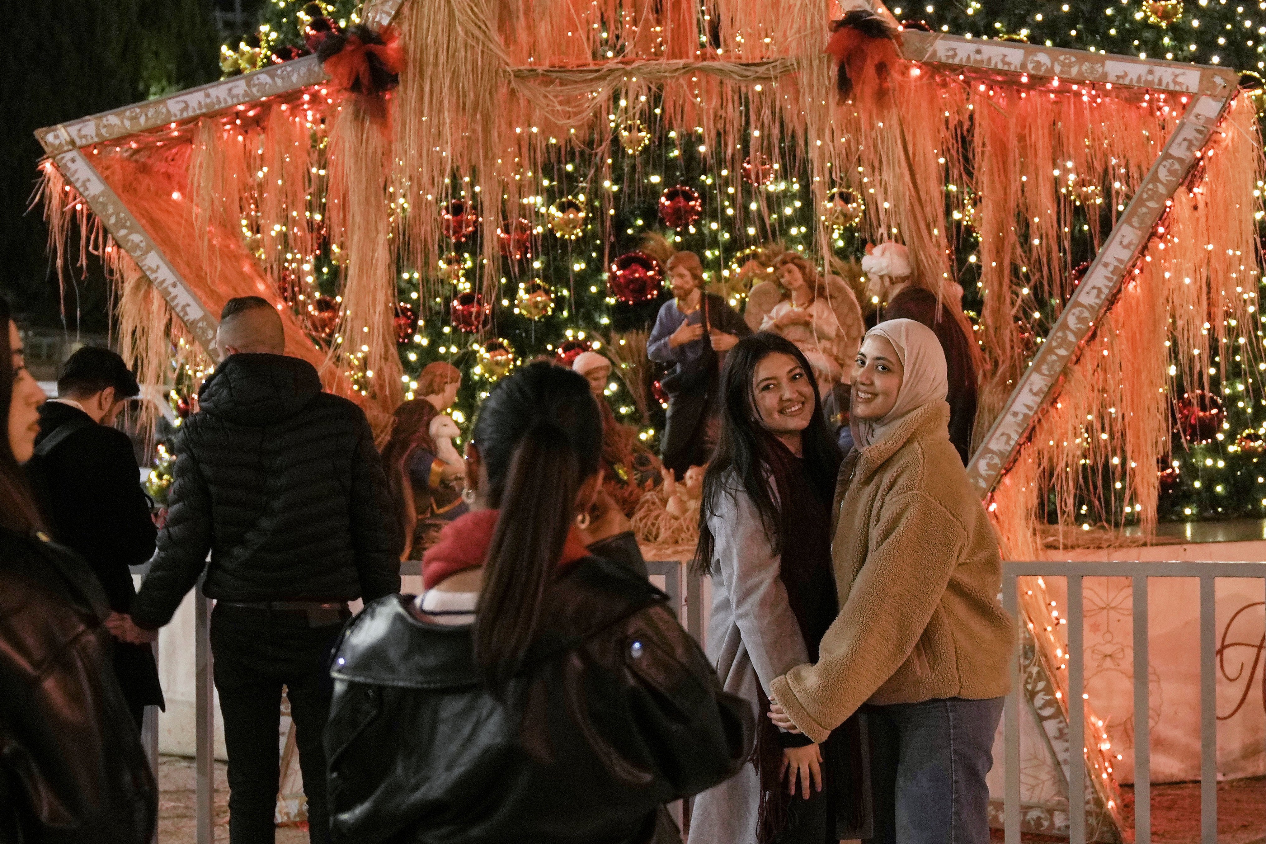 Women pose for a picture in Manger Square in the West Bank city of Bethlehem on Tuesday. Photo: AP
