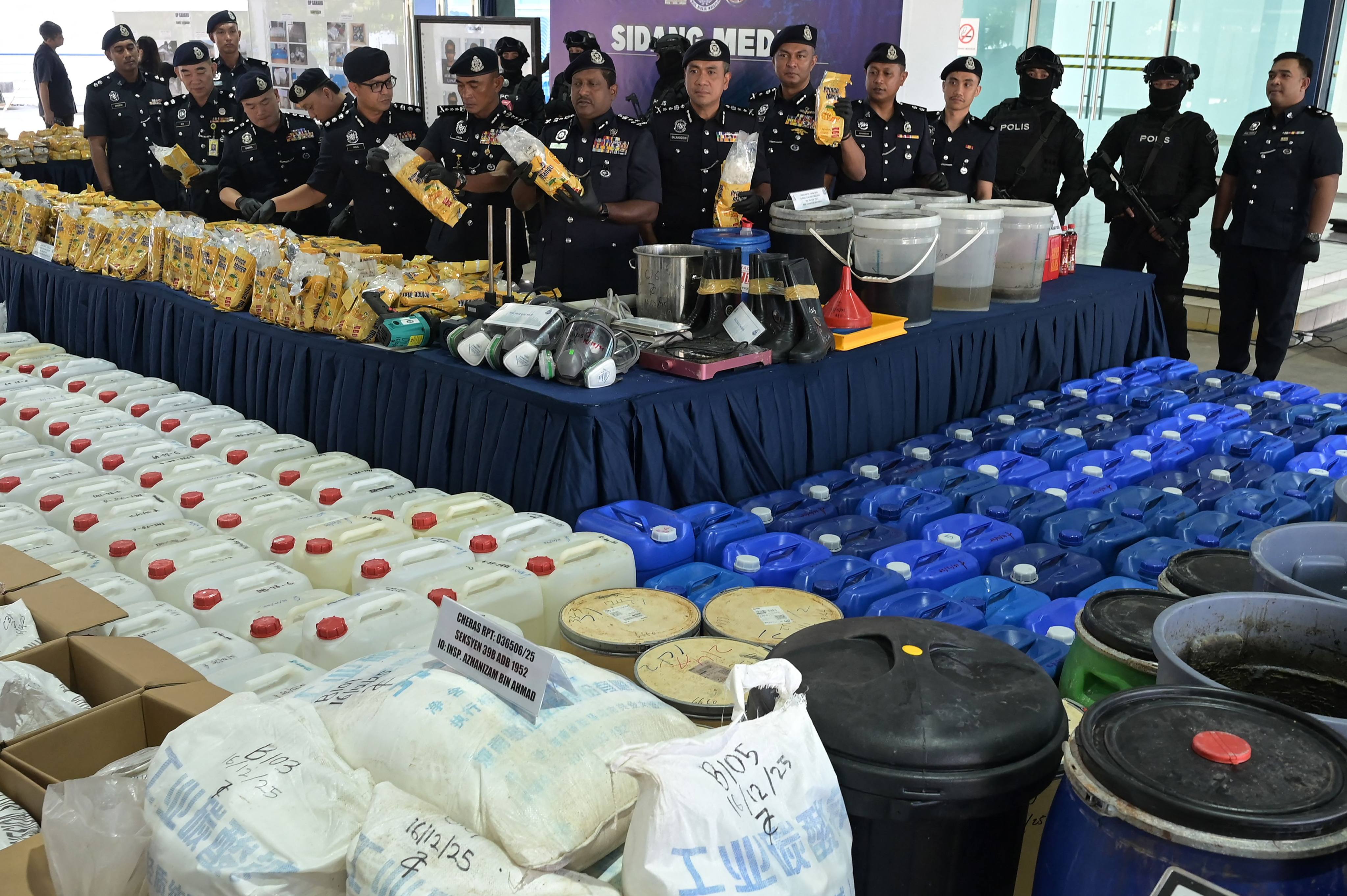 Royal Malaysia Police display seized drugs and manufacturing equipment at a Saturday press conference in Kuala Lumpur. Photo: AFP