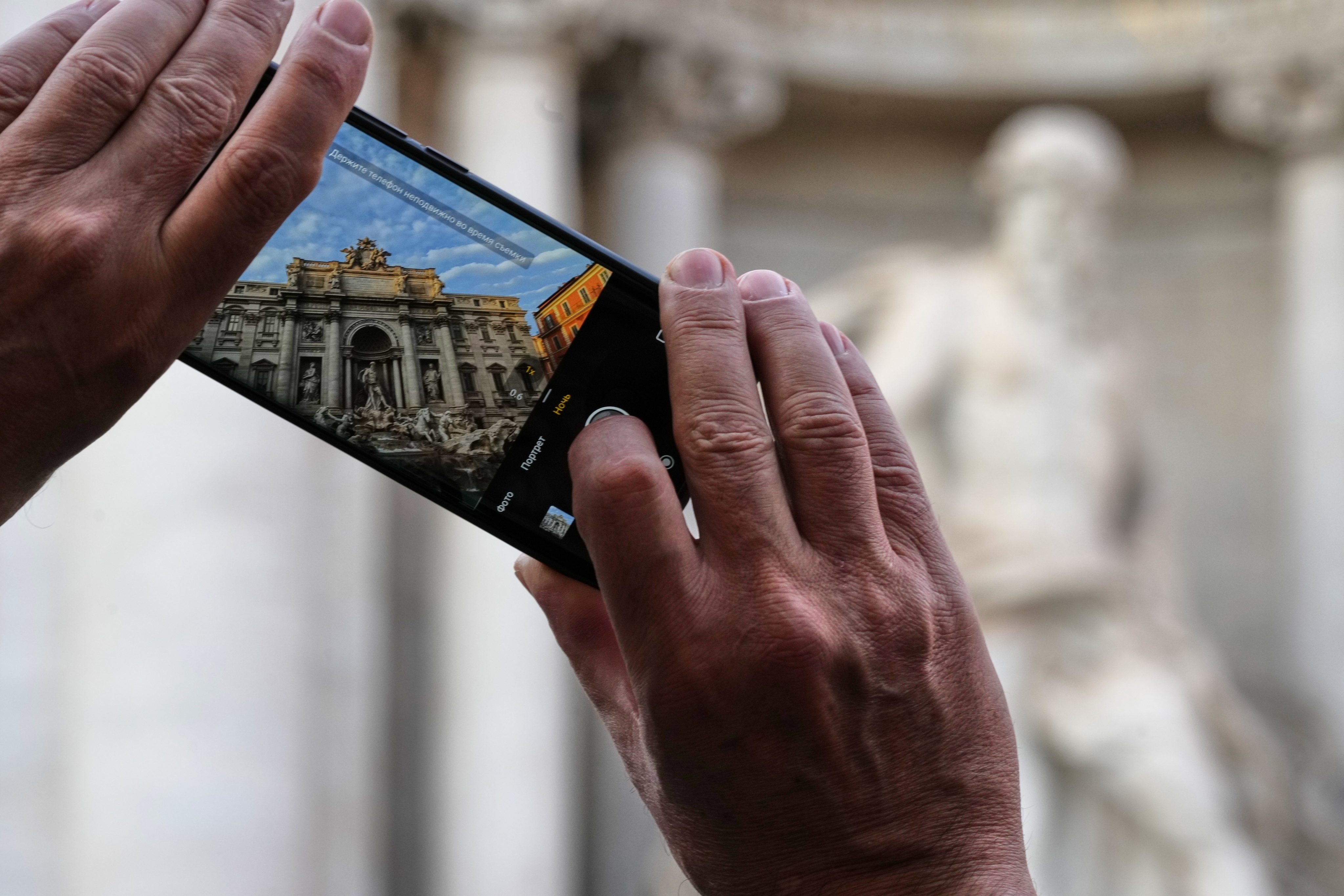 A visitor takes a photo of Rome’s Trevi Fountain on Friday. Photo: AP