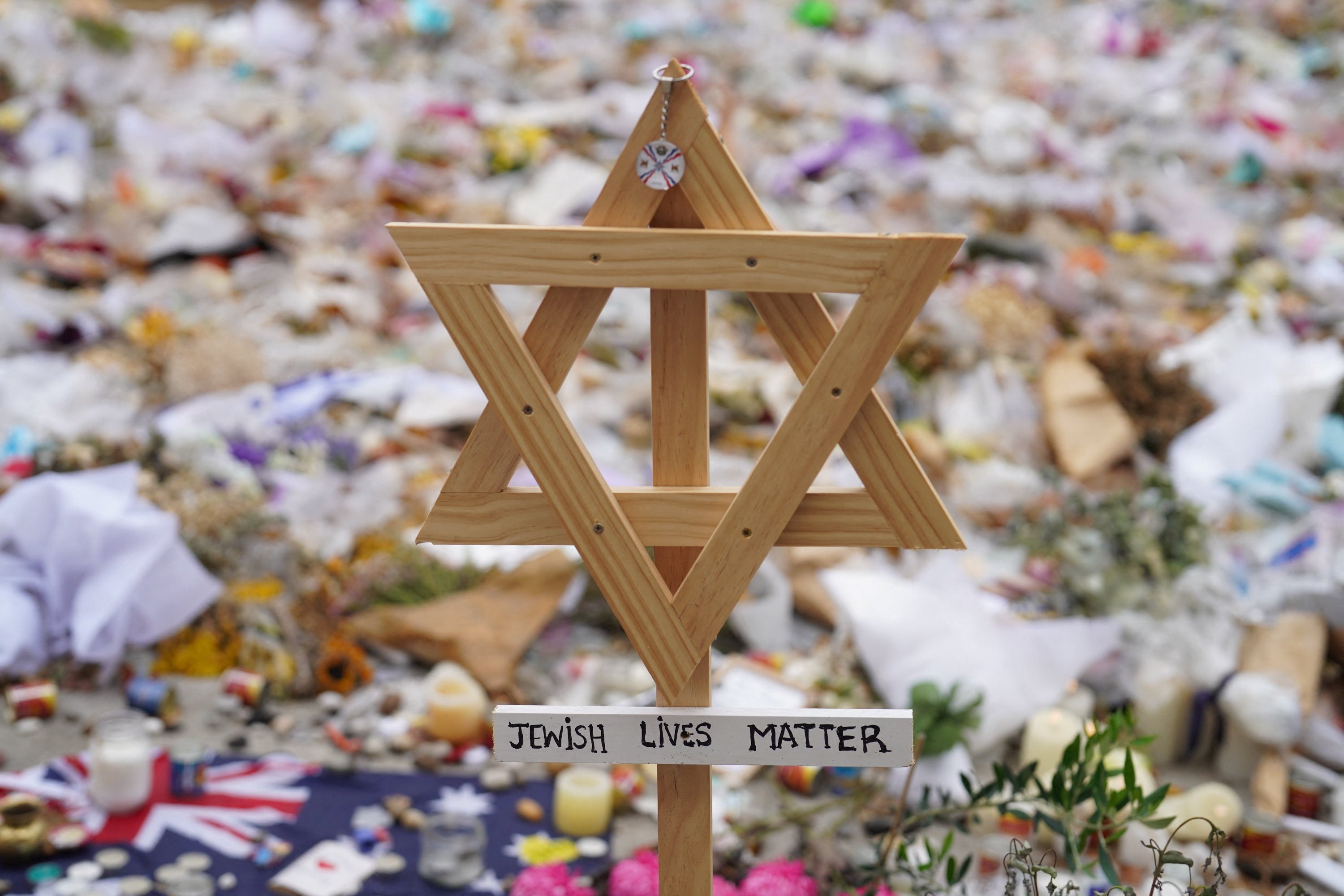 A wooden Star of David stands in a makeshift memorial to pay tribute to the victims of Sunday’s mass shooting on Bondi Beach. Photo: Reuters