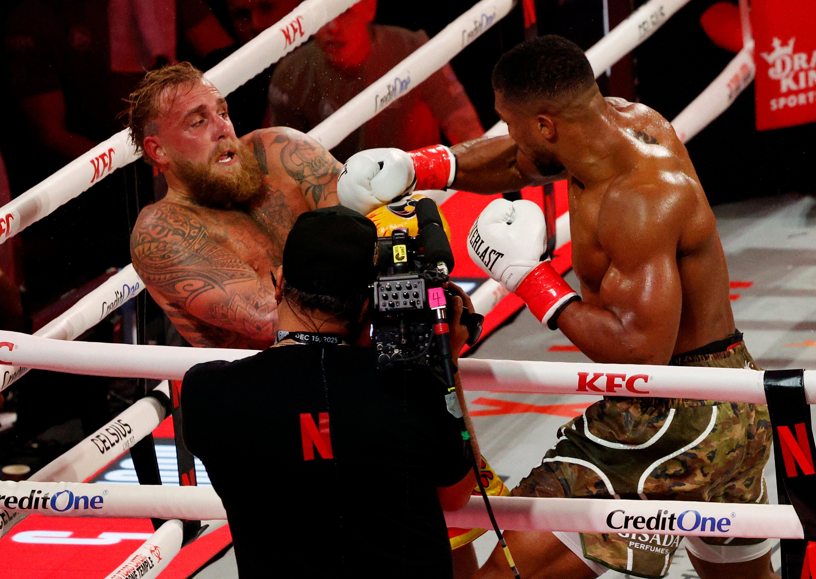 Jake Paul (left) does his best to avoid a swinging right hand from Anthony Joshua during their bout at the Kaseya Centre in Miami. Photo: Reuters