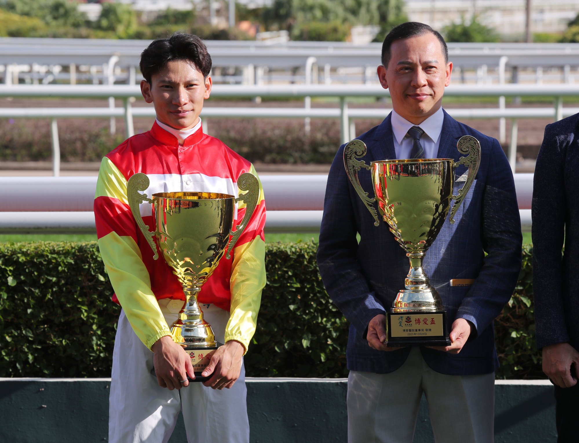 Jockey Jerry Chau and trainer Cody Mo with the Pok Oi Cups after Emblazon’s triumph.