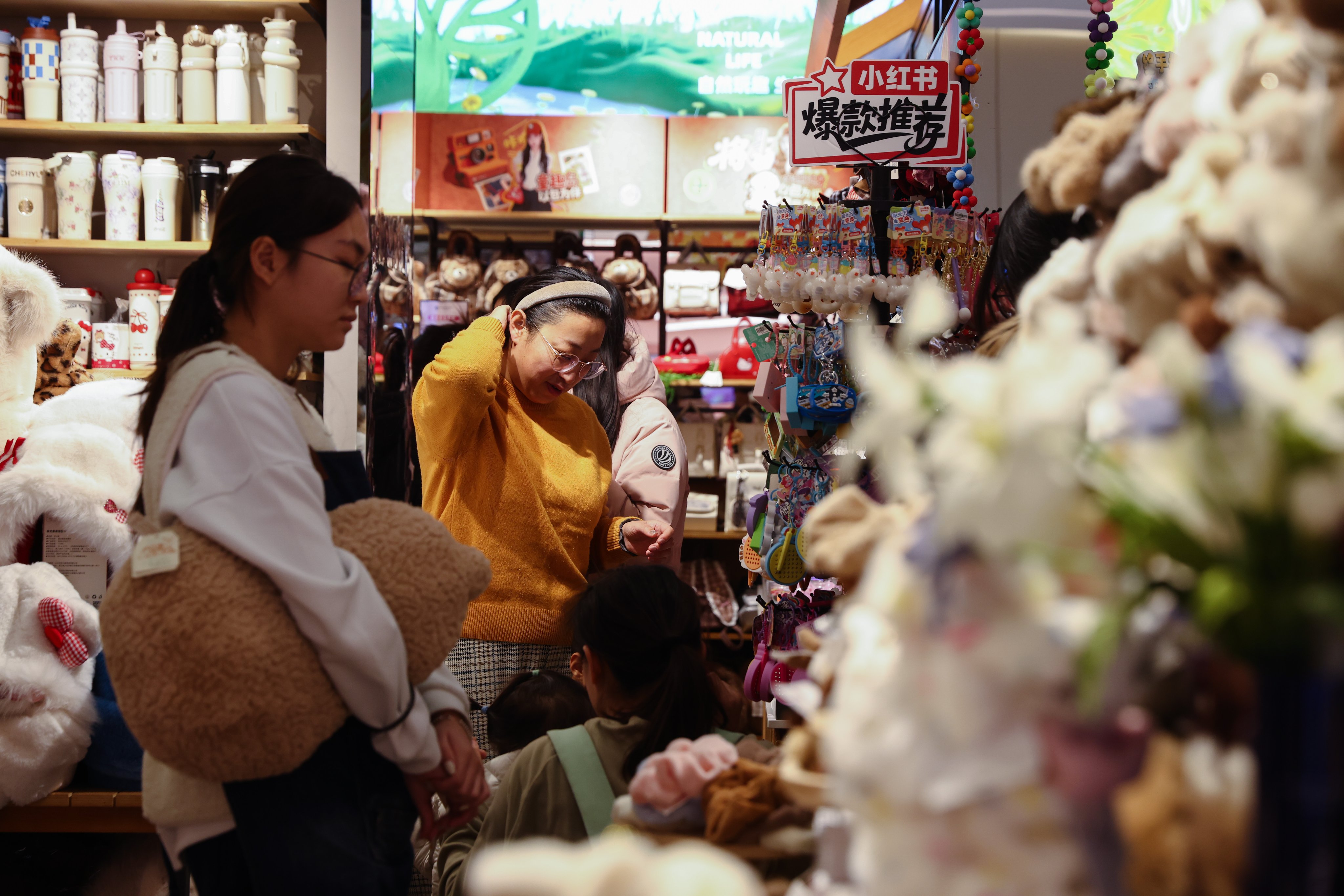 Shoppers browse goods in a gift shop in Beijing, China on December 8. Chinese authorities have highlighted tax policy as a way to support growth amid weak demand. Photo: EPA