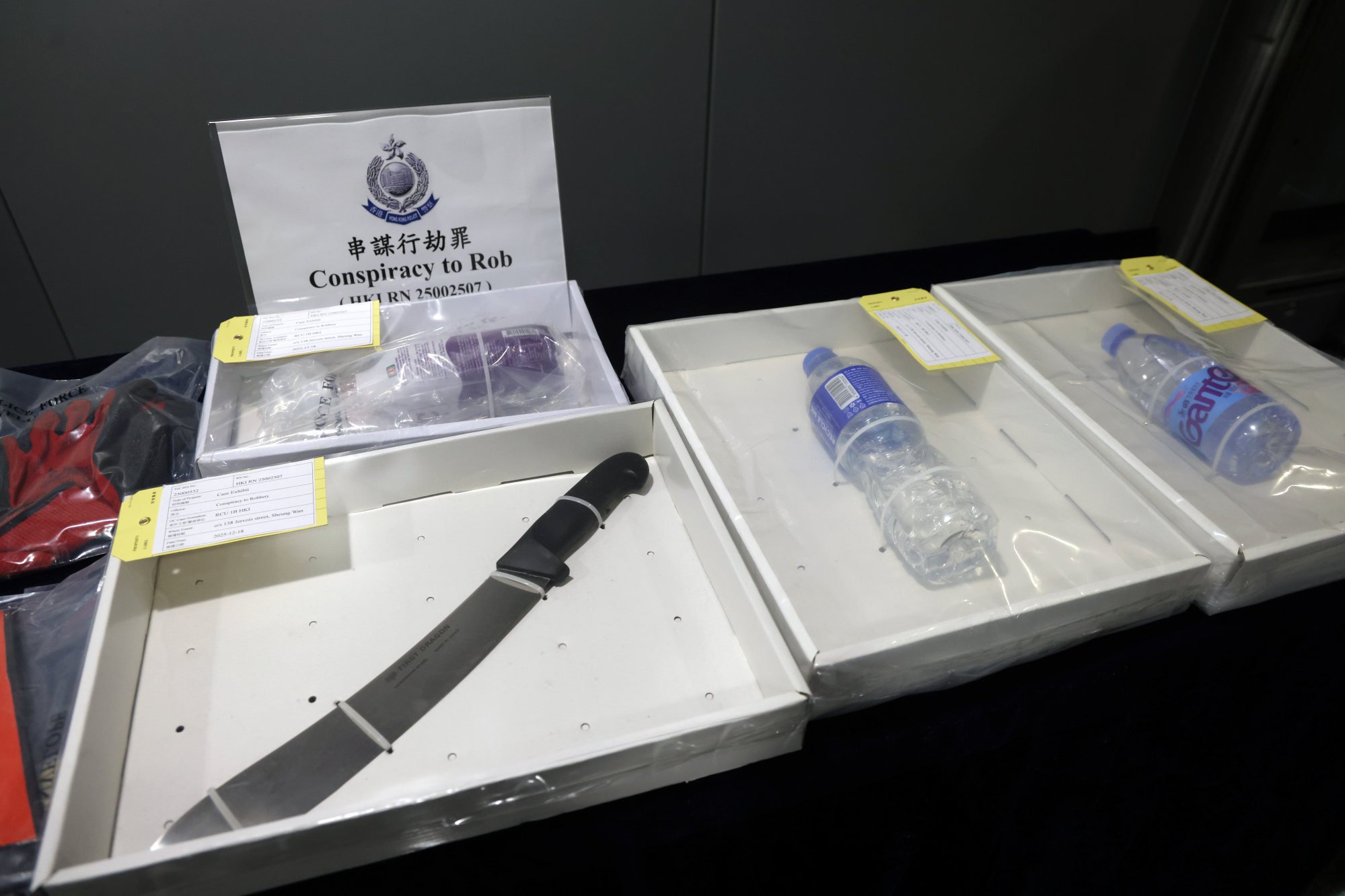Police display evidence from the crime scene, including a butcher knife. Photo: Jelly Tse