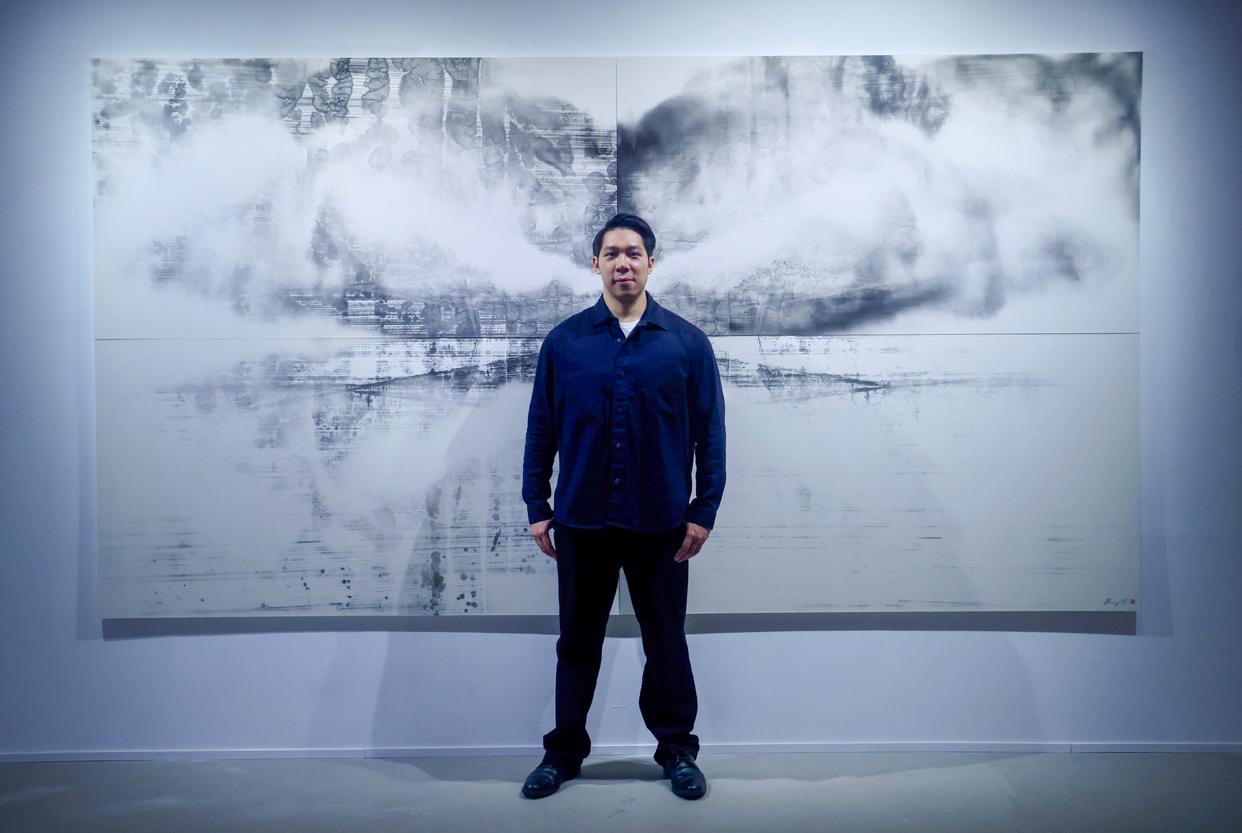 Artist Hung Fai stands in front of his work Traces XI (2025) at “A Veiled Revelation”, his new exhibition at Grotto Fine Art in Shau Kei Wan, Hong Kong. The solo exhibition is a disruption of his usual control in his work. Photo: Jonathan Wong