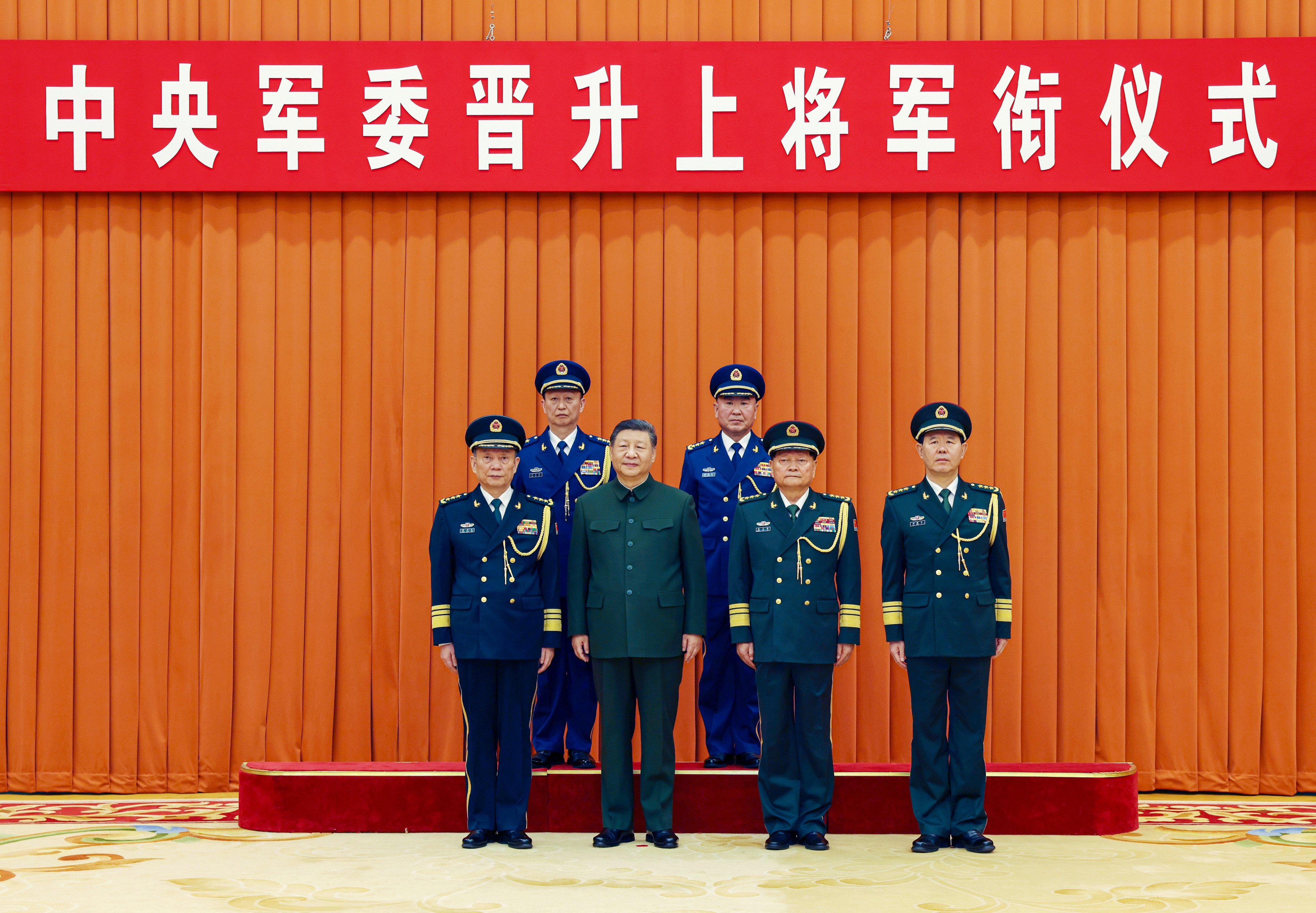 Chinese President Xi Jinping (front row, second from left), who is also chairman of the Central Military Commission, and other leaders pose for a photo with the promoted military officers in Beijing on Monday. Photo: Xinhua