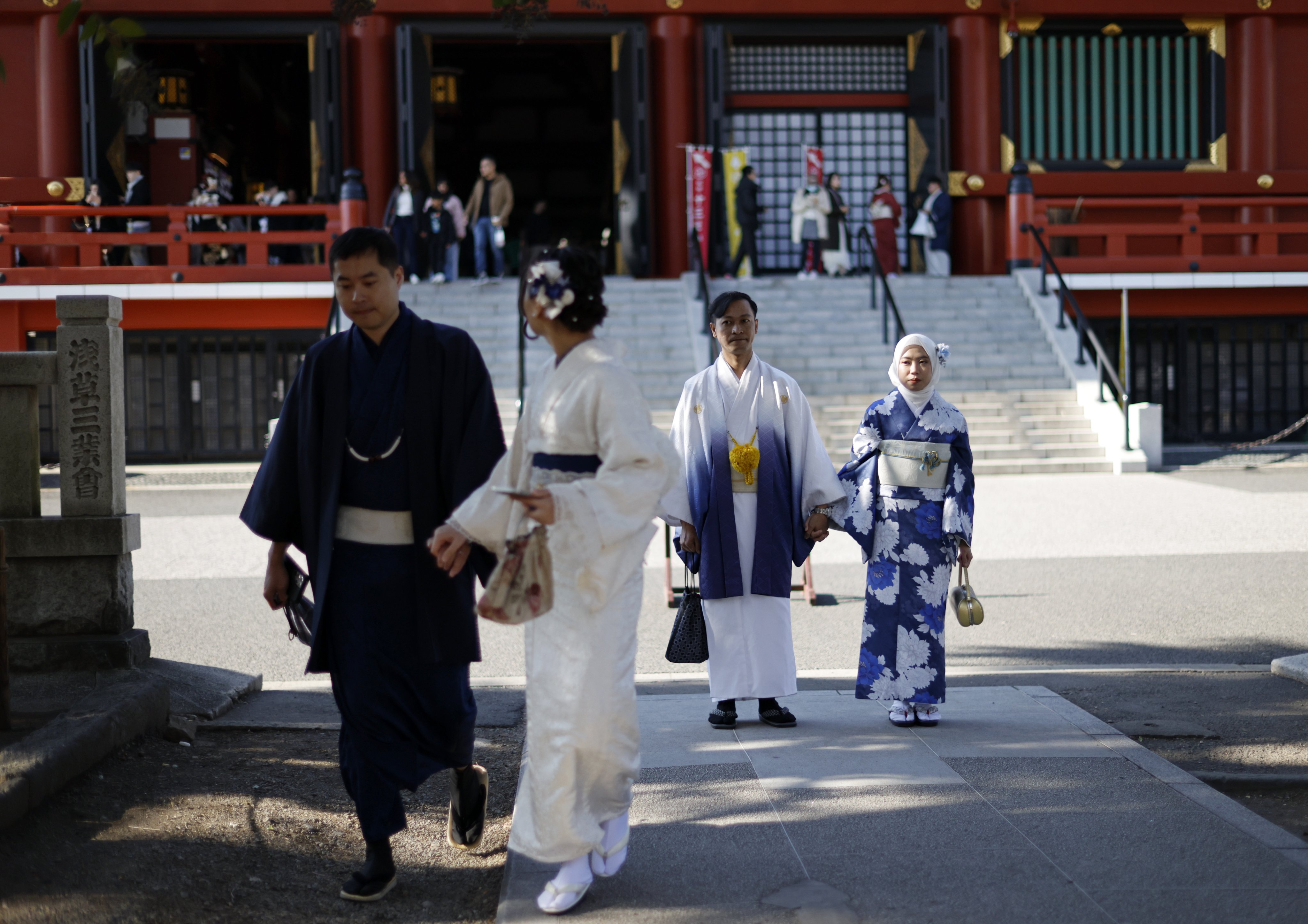 Visitors don traditional outfits to visit the Sensoji Temple at Asakusa district in Tokyo on Friday. Photo: EPA